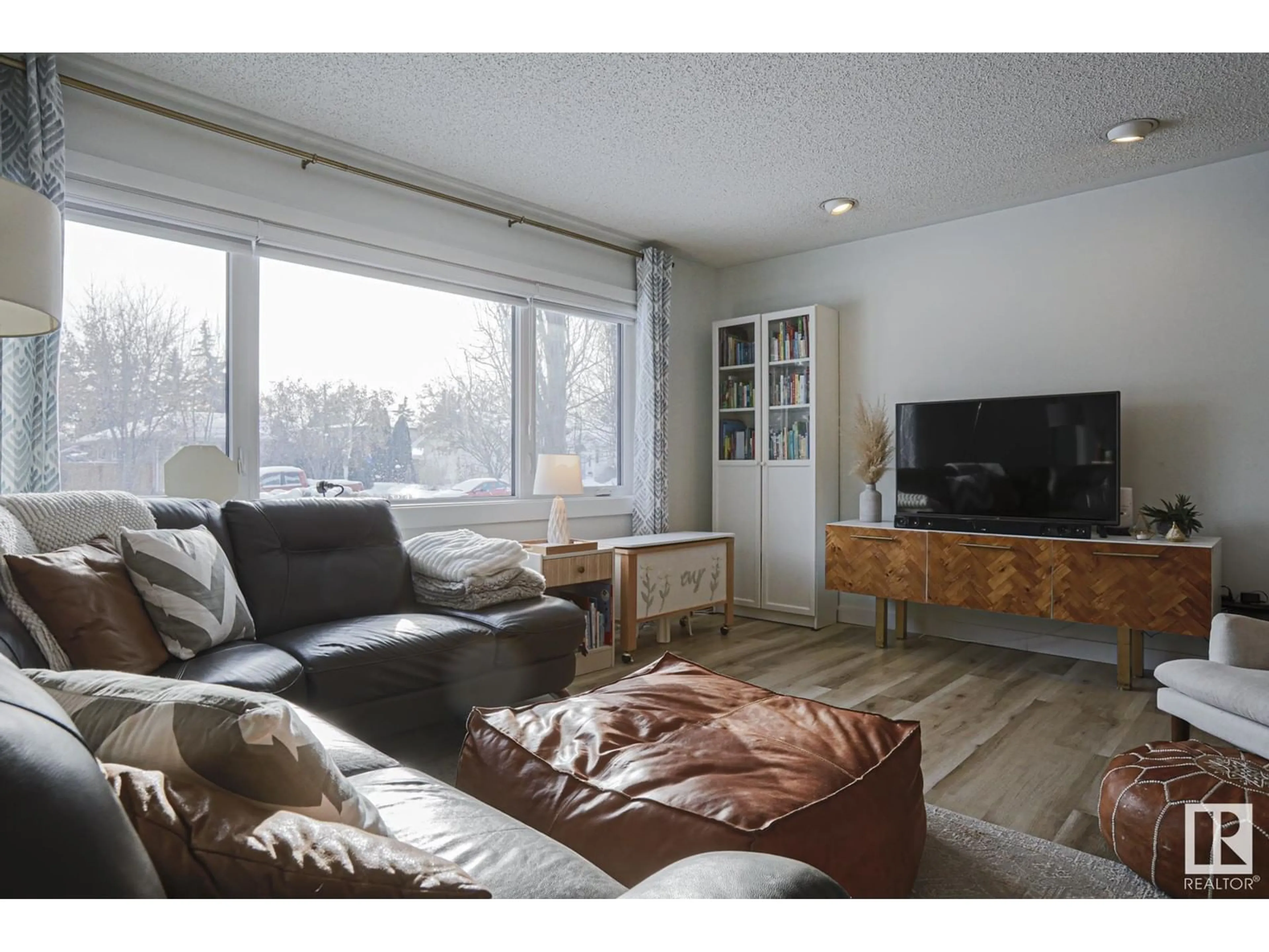 Living room with furniture, wood/laminate floor for 14704 84 AV NW, Edmonton Alberta T5R3X2