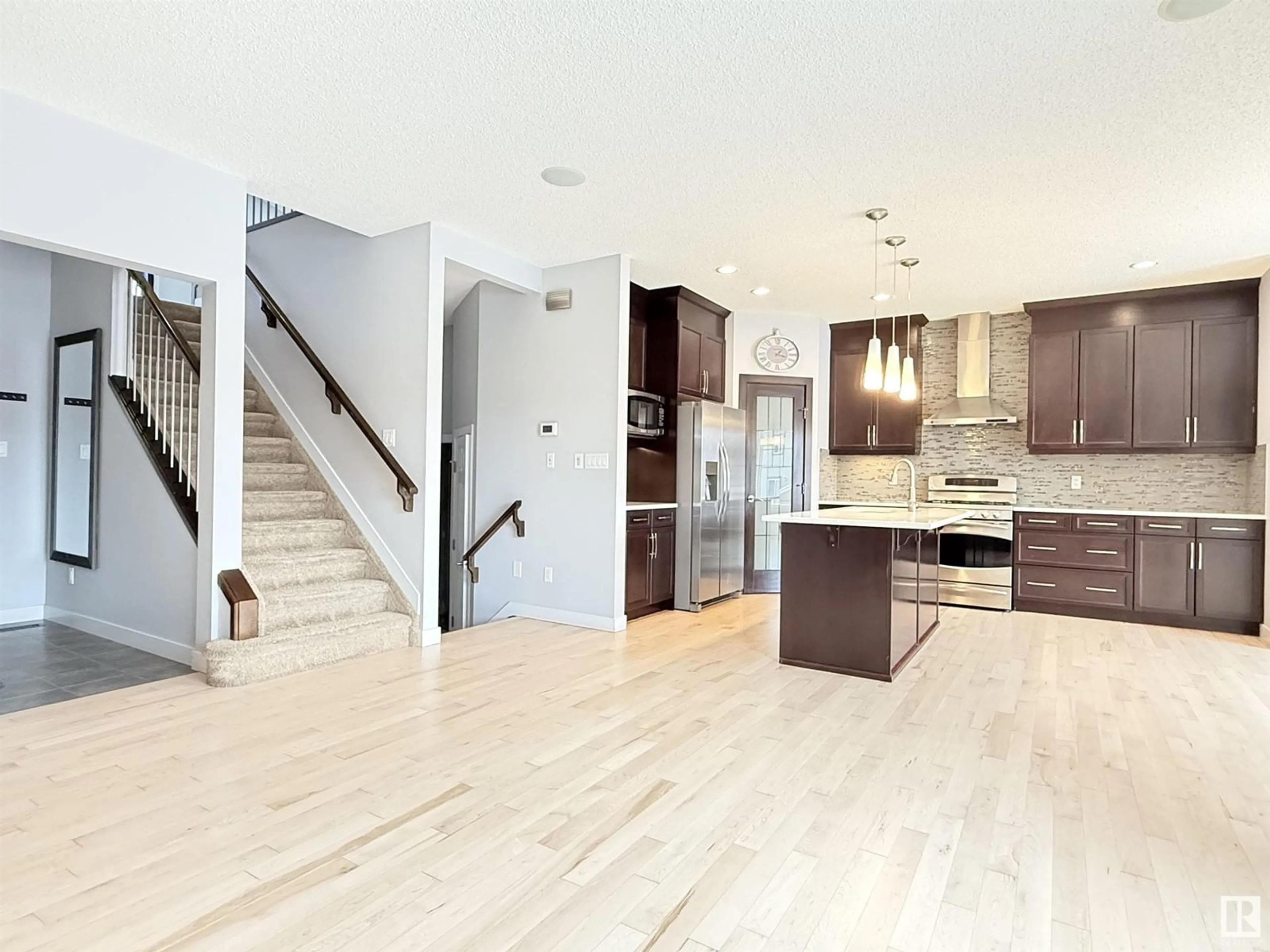 Open concept kitchen, wood/laminate floor for 4211 CHARLES CL SW, Edmonton Alberta T6W0Z5