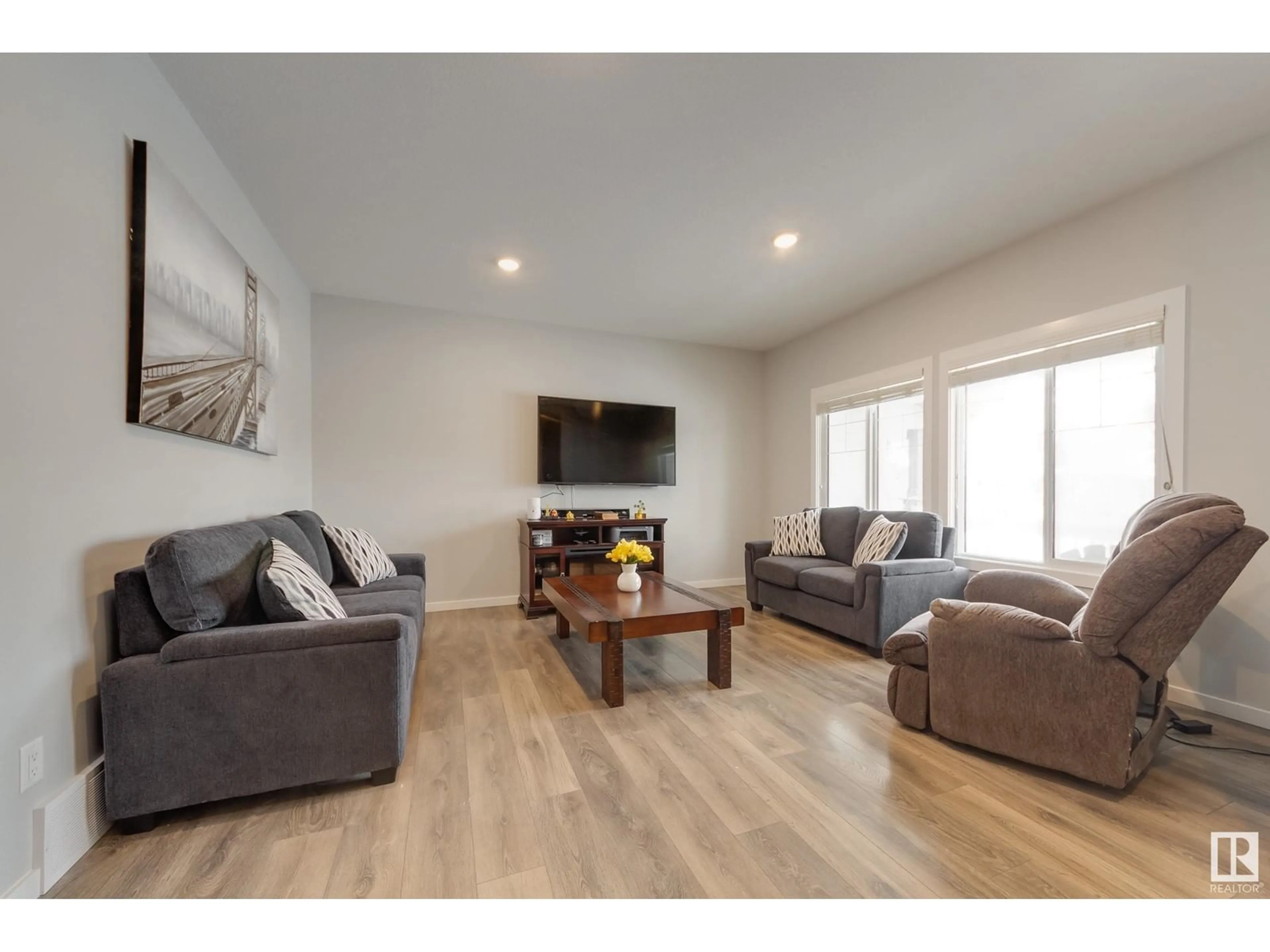 Living room with furniture, wood/laminate floor for 2440 18 AV NW, Edmonton Alberta T6T2G7