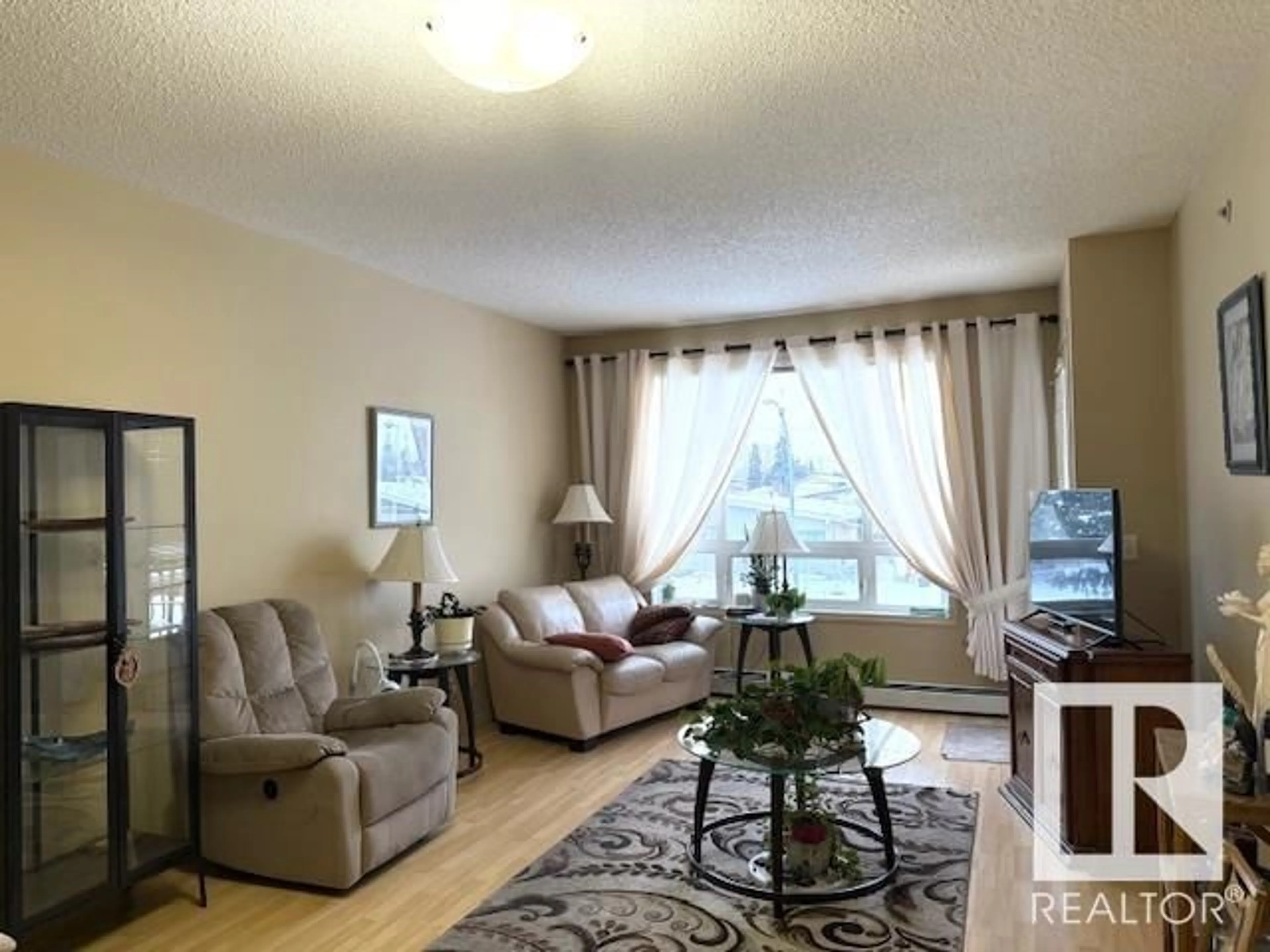 Living room with furniture, unknown for #207 6315 135 AV NW, Edmonton Alberta T5A5J7