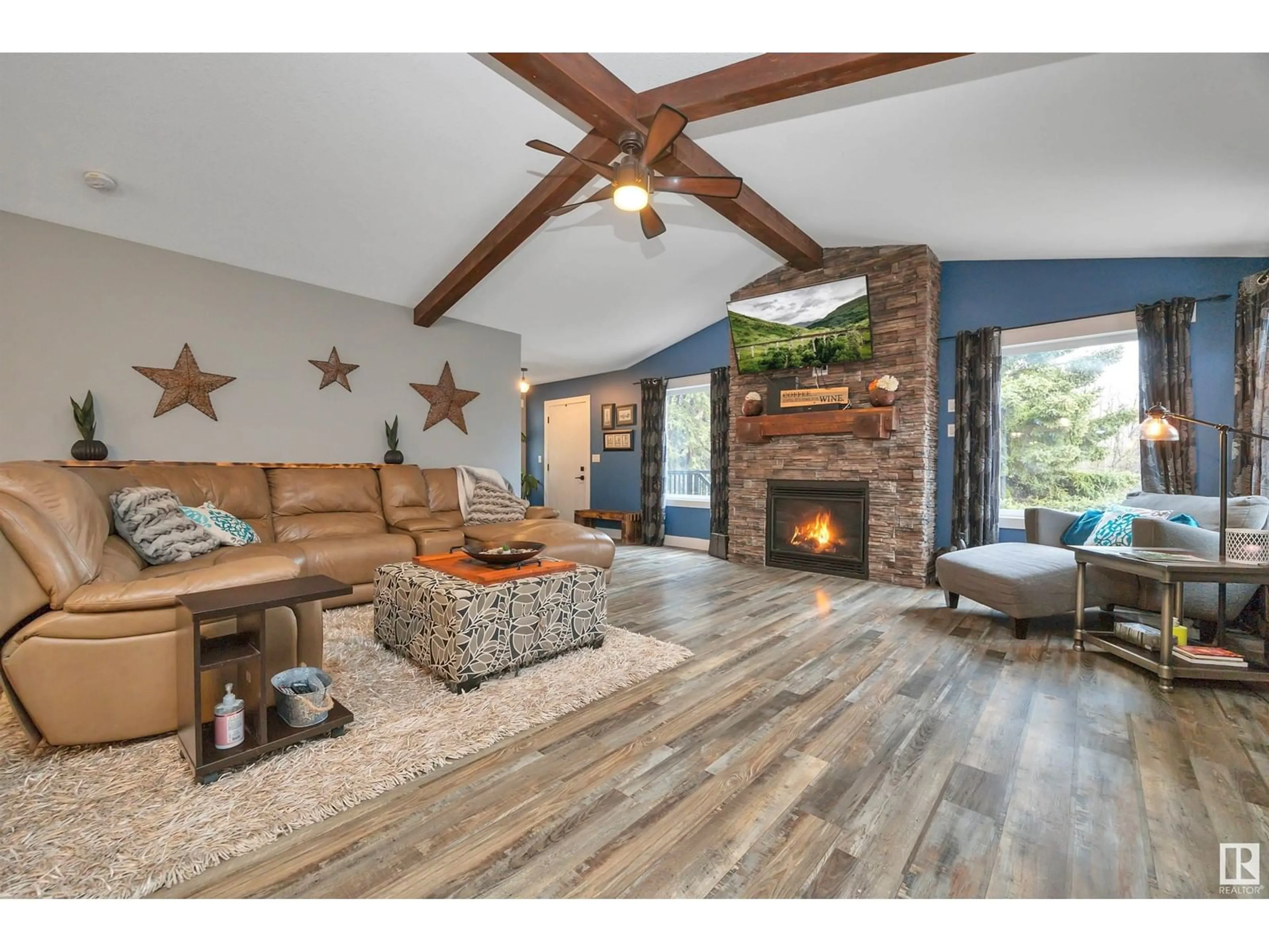 Living room with furniture, wood/laminate floor for 49124 RGE RD 275, Rural Leduc County Alberta T0C2P0