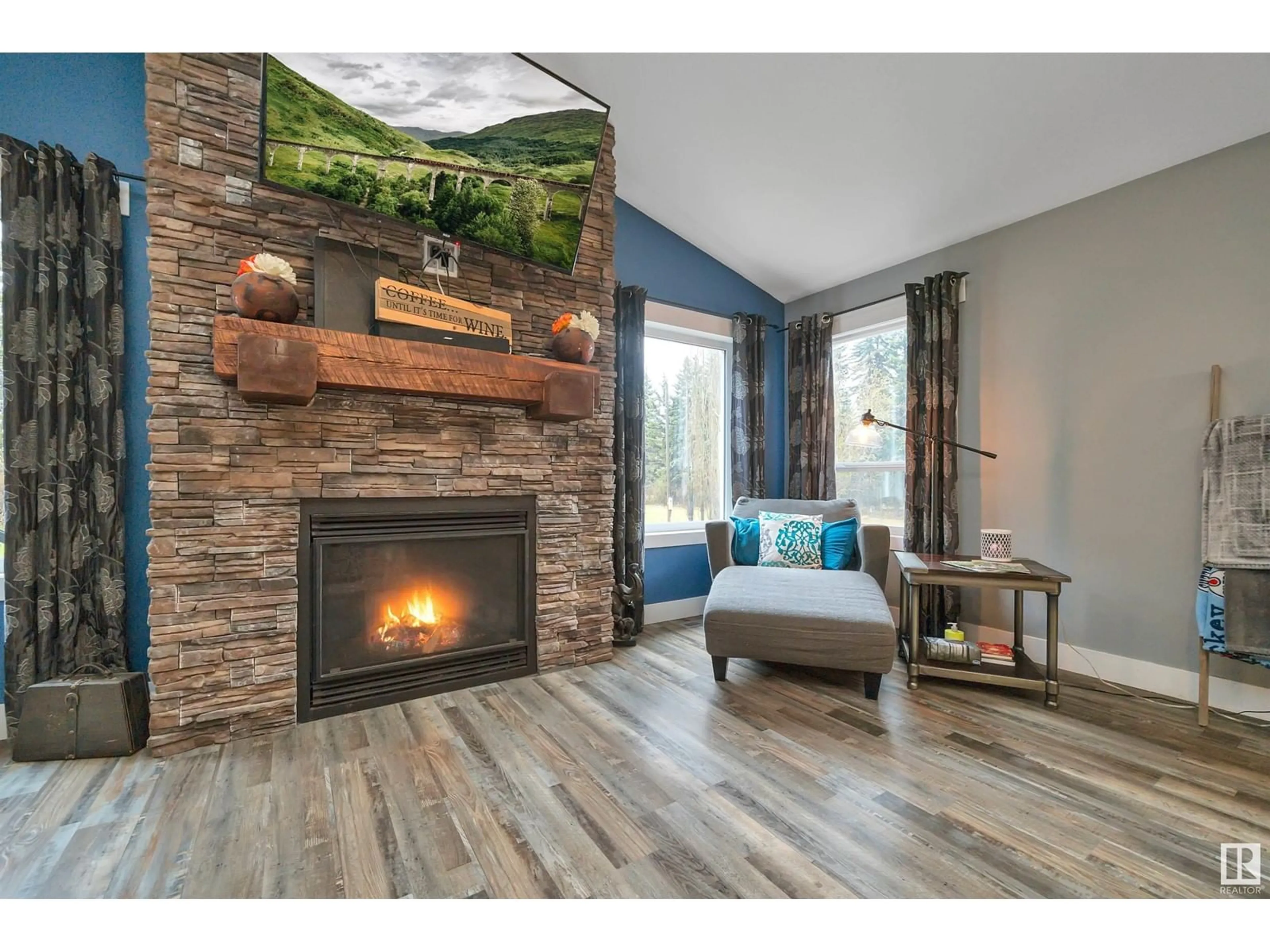Living room with furniture, wood/laminate floor for 49124 RGE RD 275, Rural Leduc County Alberta T0C2P0