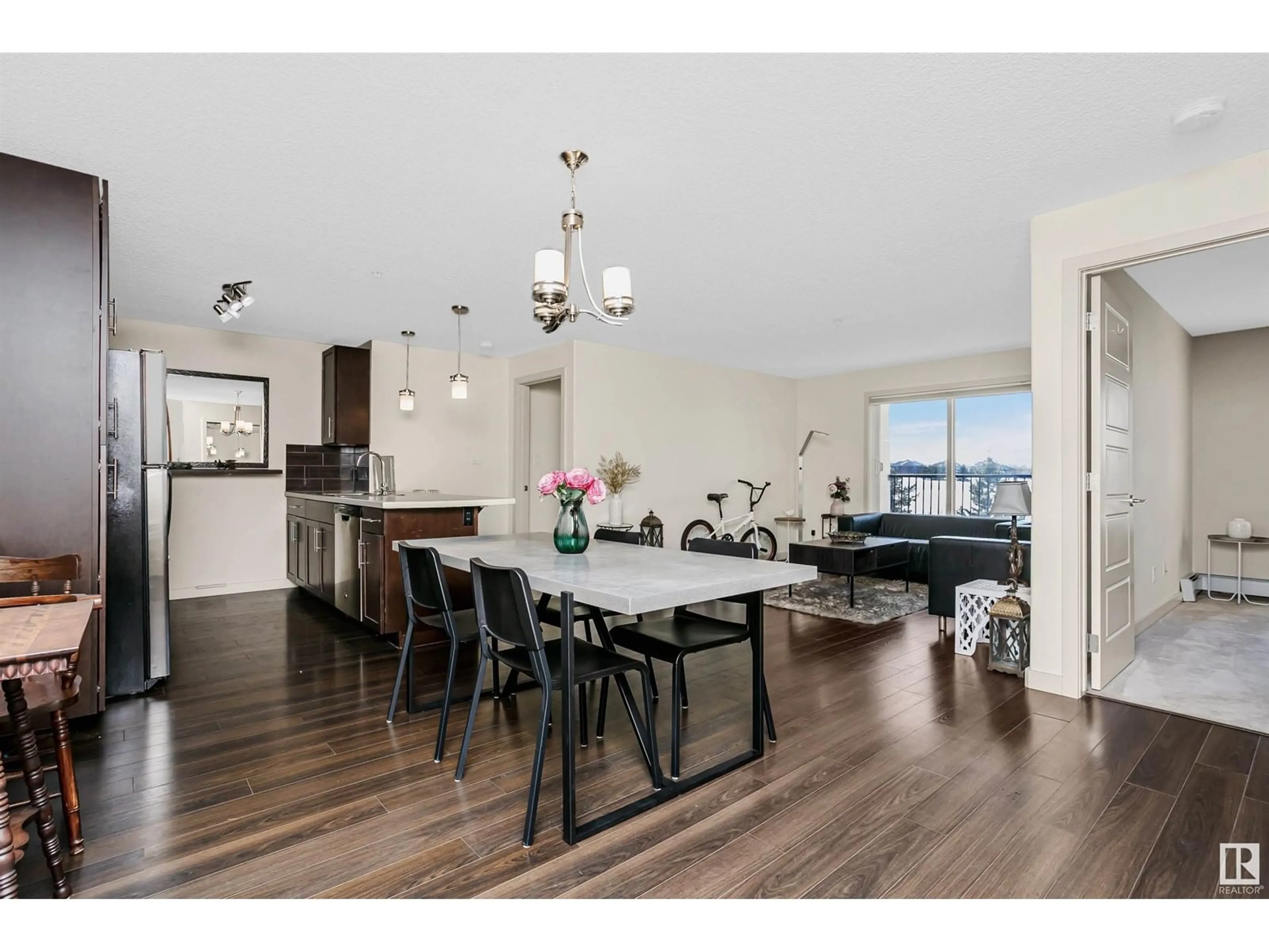 Open concept kitchen, wood/laminate floor for #309 6084 STANTON DR SW, Edmonton Alberta T6X0Z4