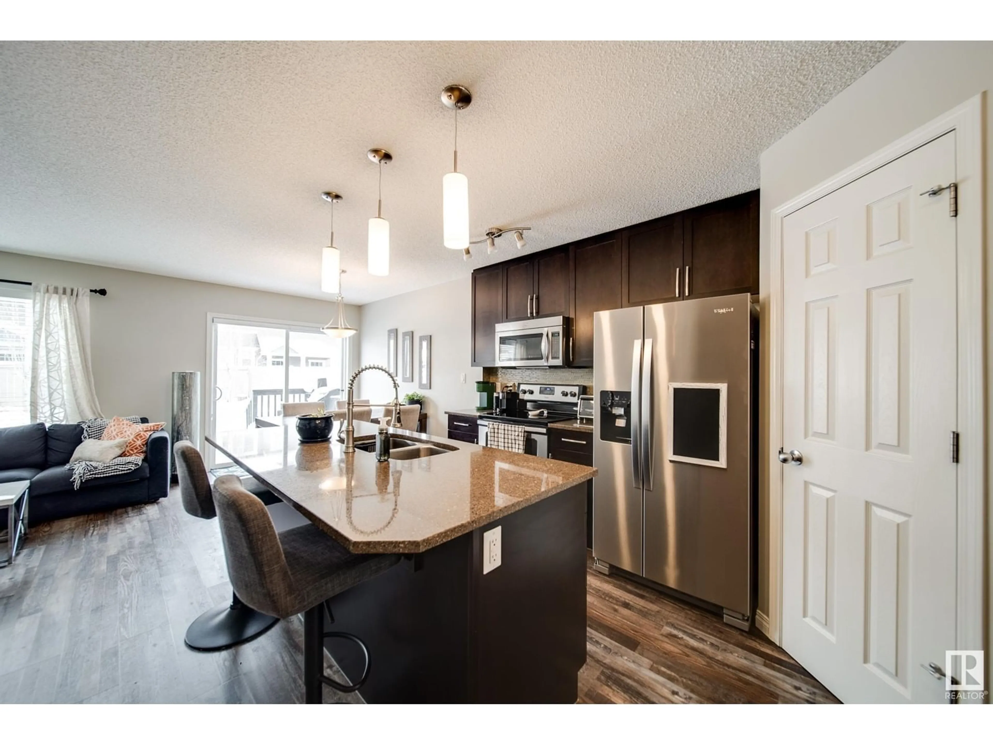 Open concept kitchen, wood/laminate floor for 1733 CHAPMAN WY SW, Edmonton Alberta T6W2E8