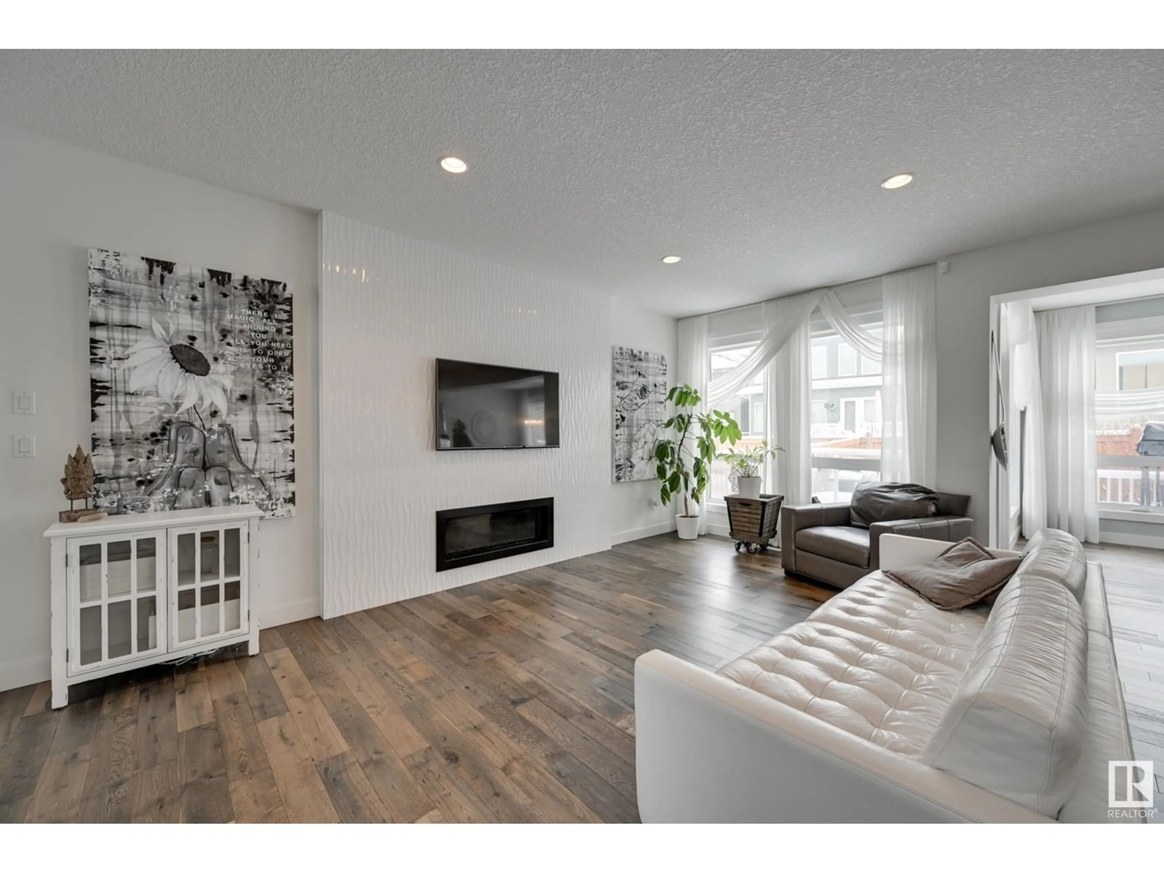 Living room with furniture, wood/laminate floor for 1311 HAINSTOCK WY, Edmonton Alberta T6W3B6