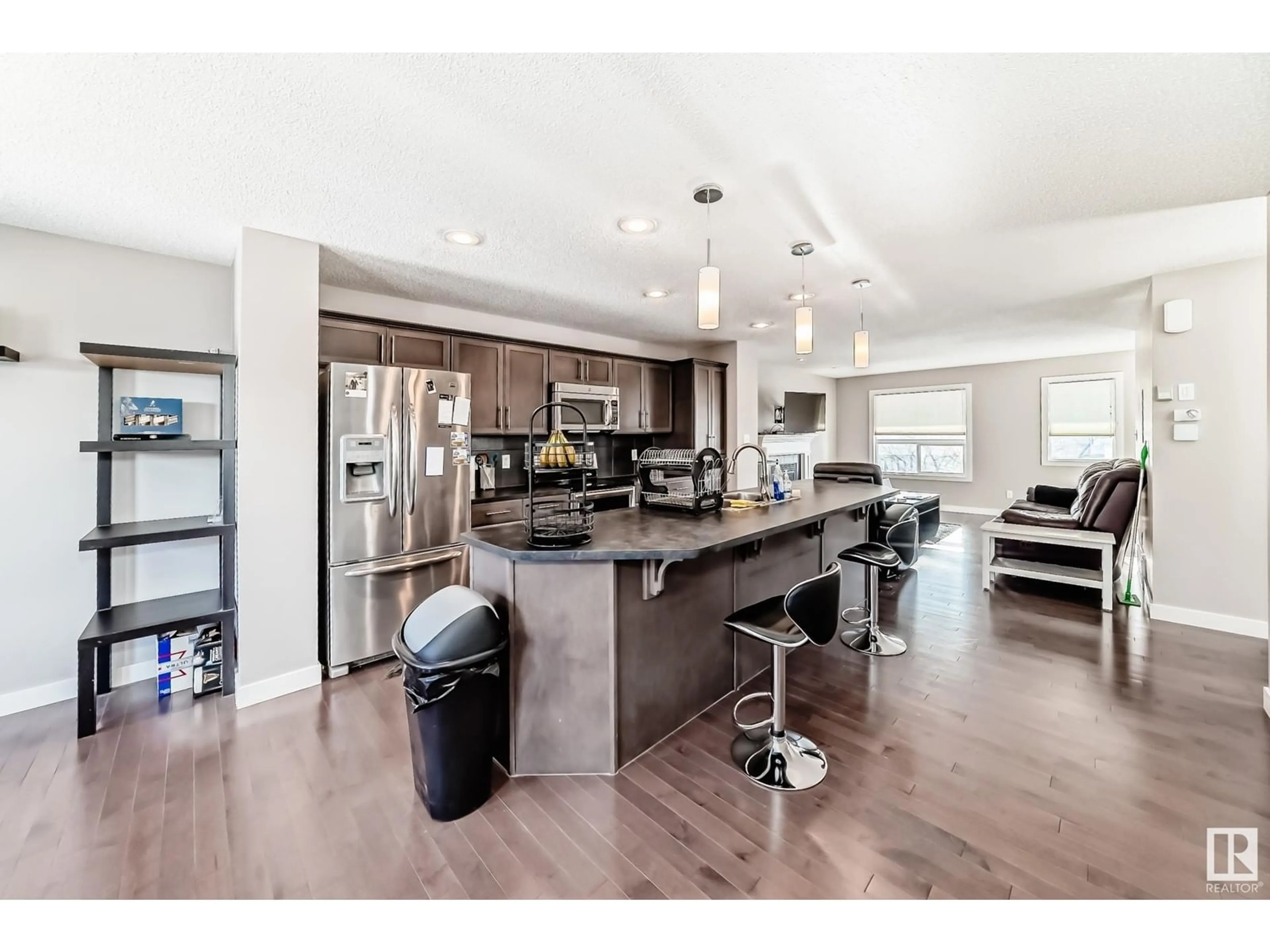 Open concept kitchen, wood/laminate floor for 17804 6 AV SW, Edmonton Alberta T6W2G6