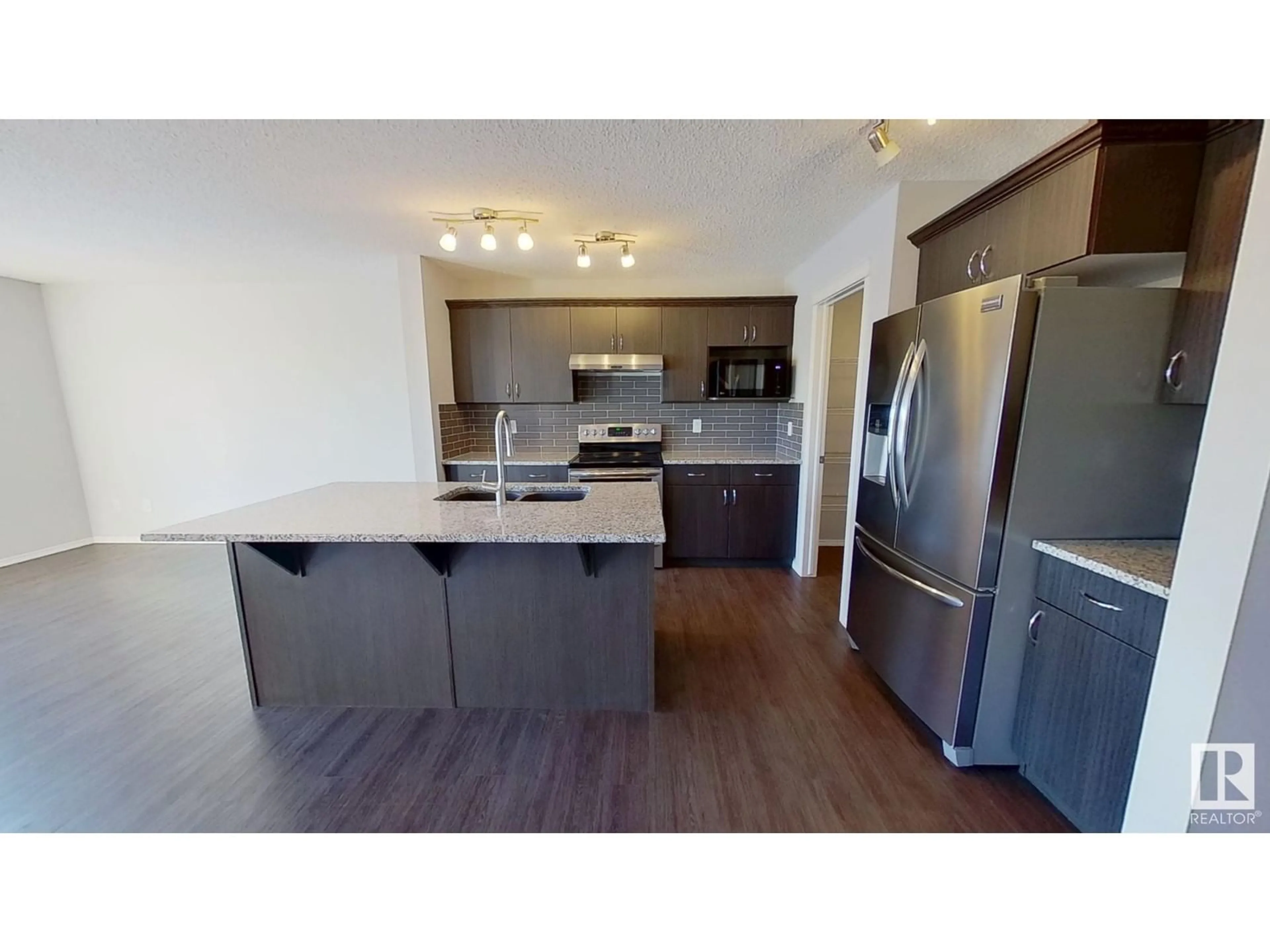 Open concept kitchen, wood/laminate floor for 17043 38 ST NW, Edmonton Alberta T5Y3S1