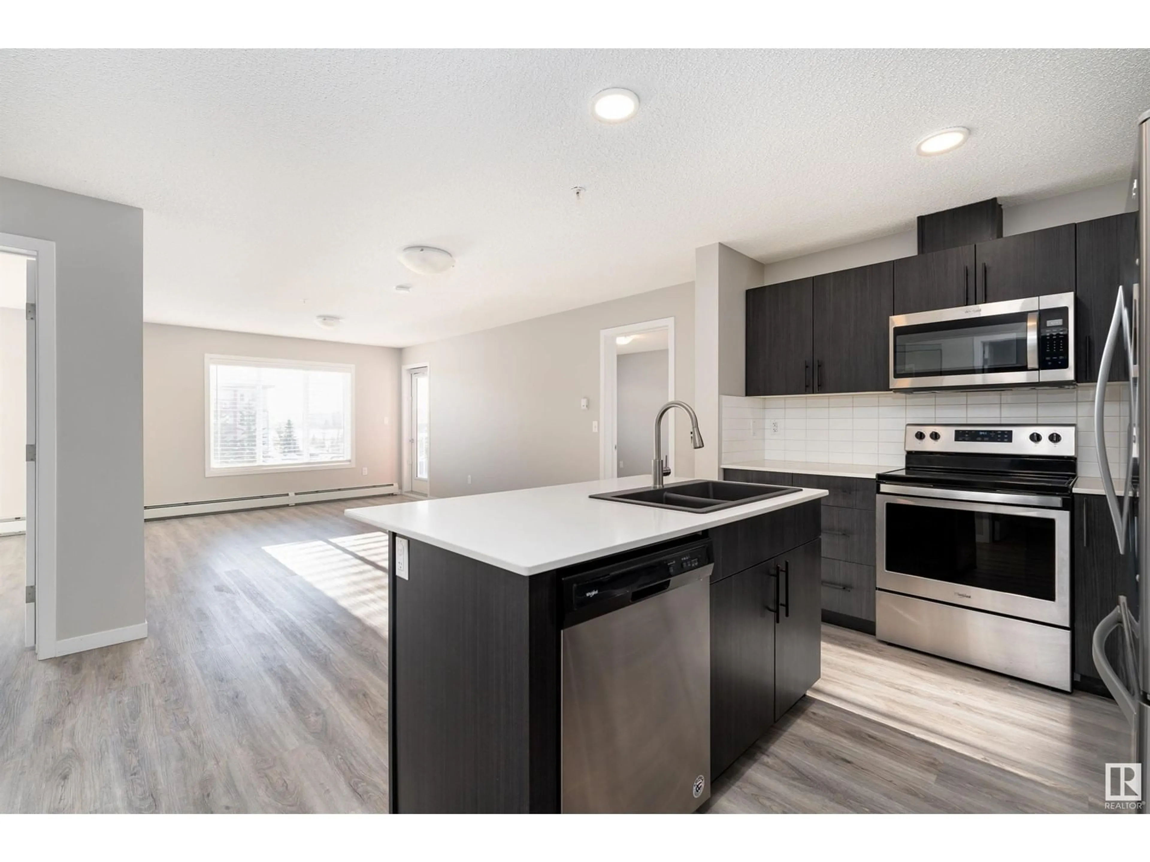 Open concept kitchen, wood/laminate floor for #352 1818 RUTHERFORD RD SW, Edmonton Alberta T6W2K6