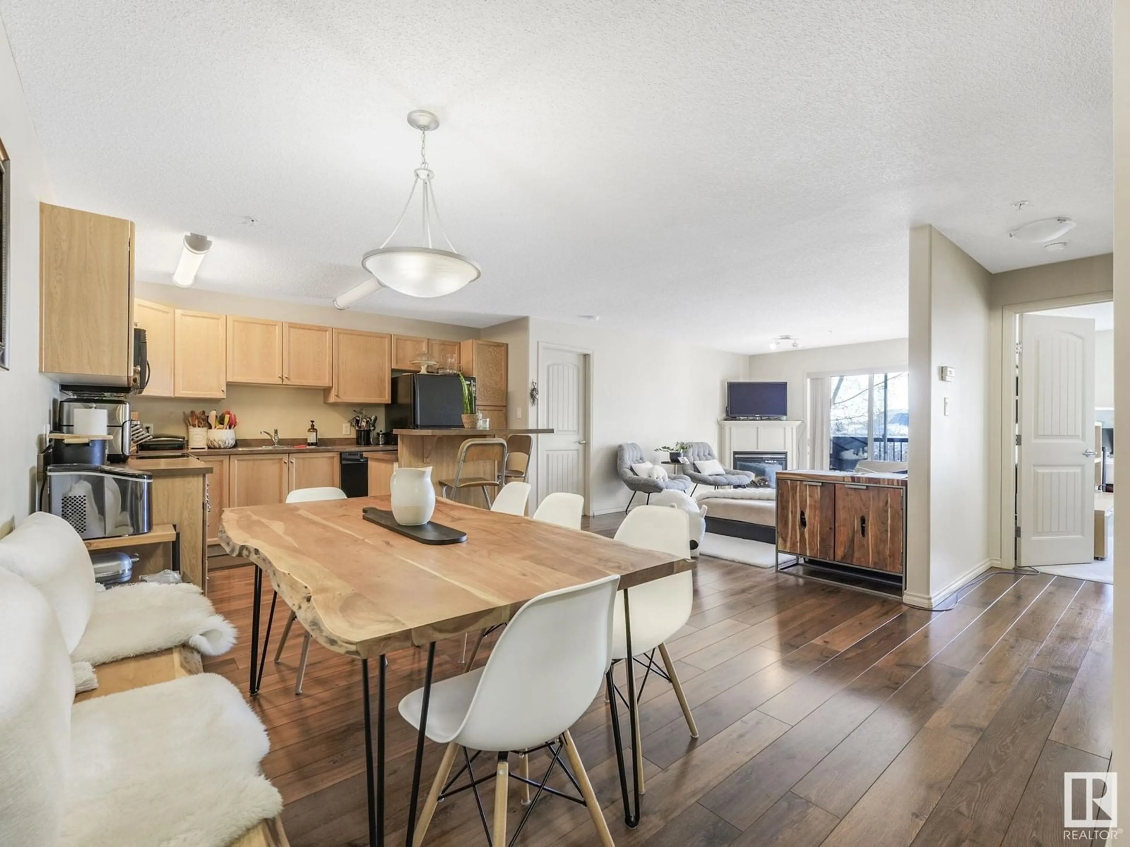 Open concept kitchen, wood/laminate floor for #320 17415 99 AV NW, Edmonton Alberta T5T0W8