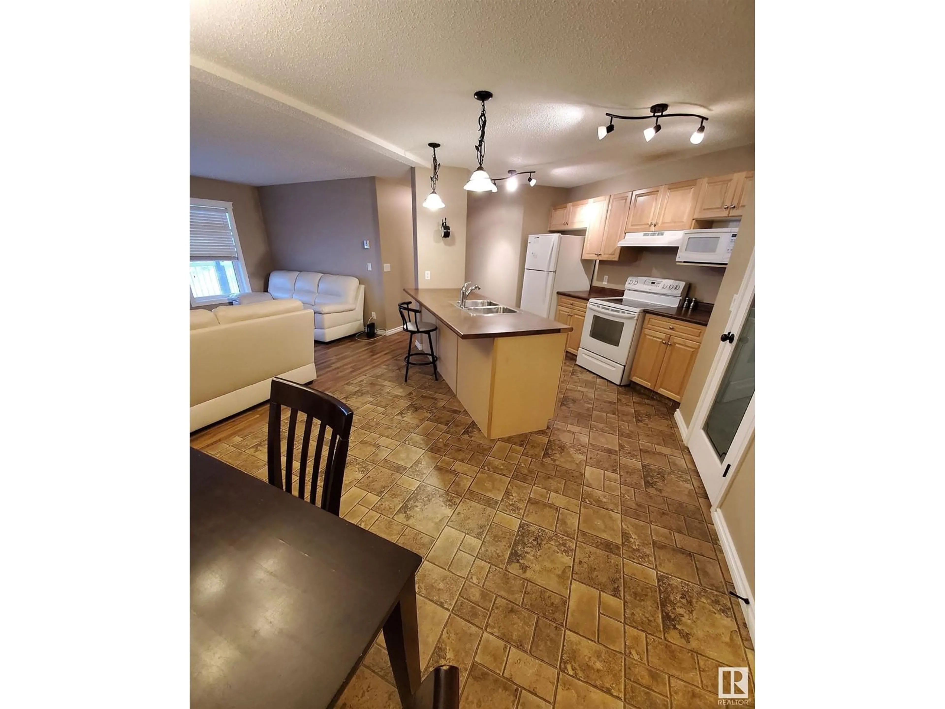 Open concept kitchen, wood/laminate floor for #1203 901 16 ST, Cold Lake Alberta T9M0C3