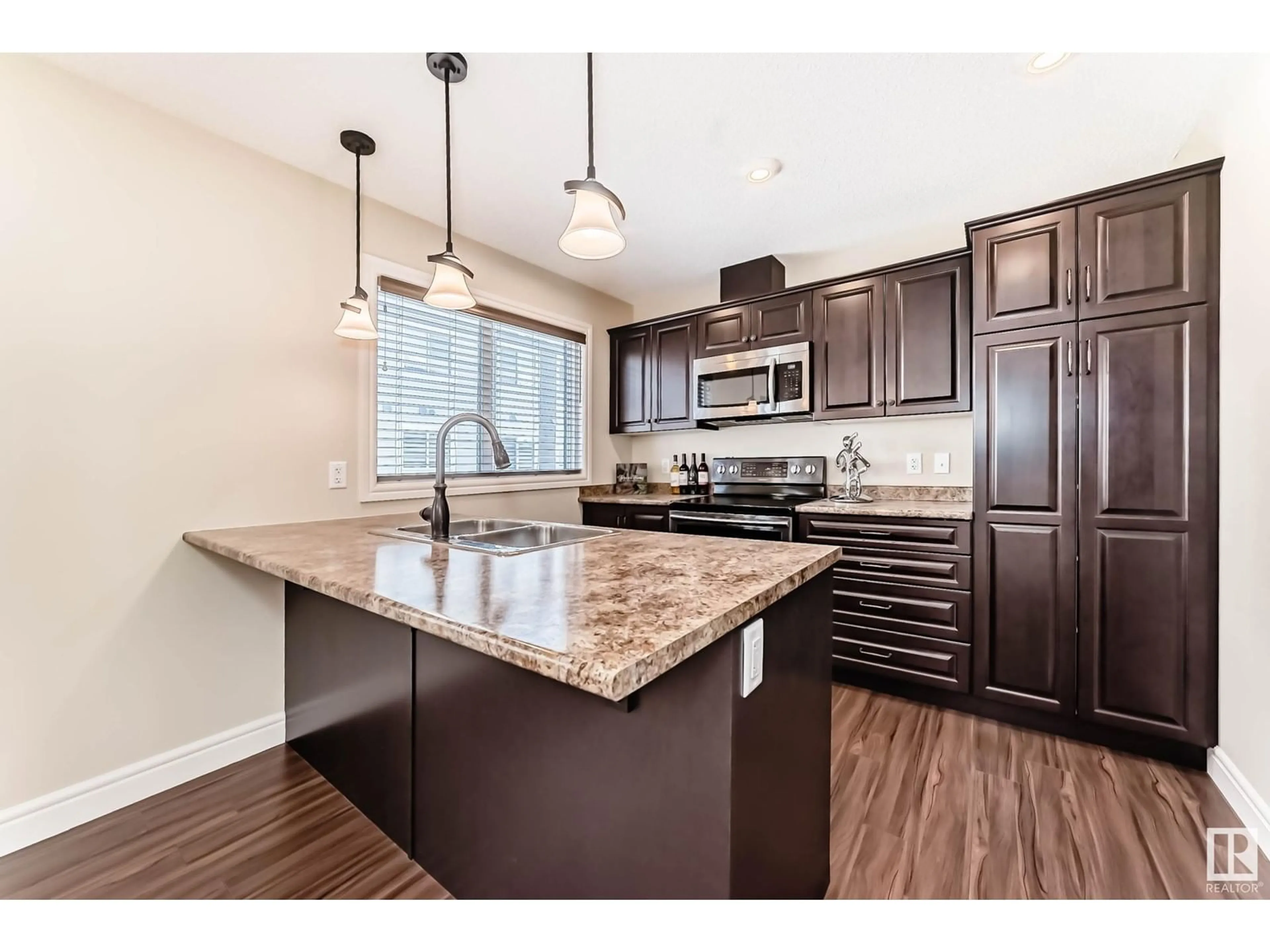 Open concept kitchen, wood/laminate floor for #56 330 BULYEA RD NW, Edmonton Alberta T6R0W8