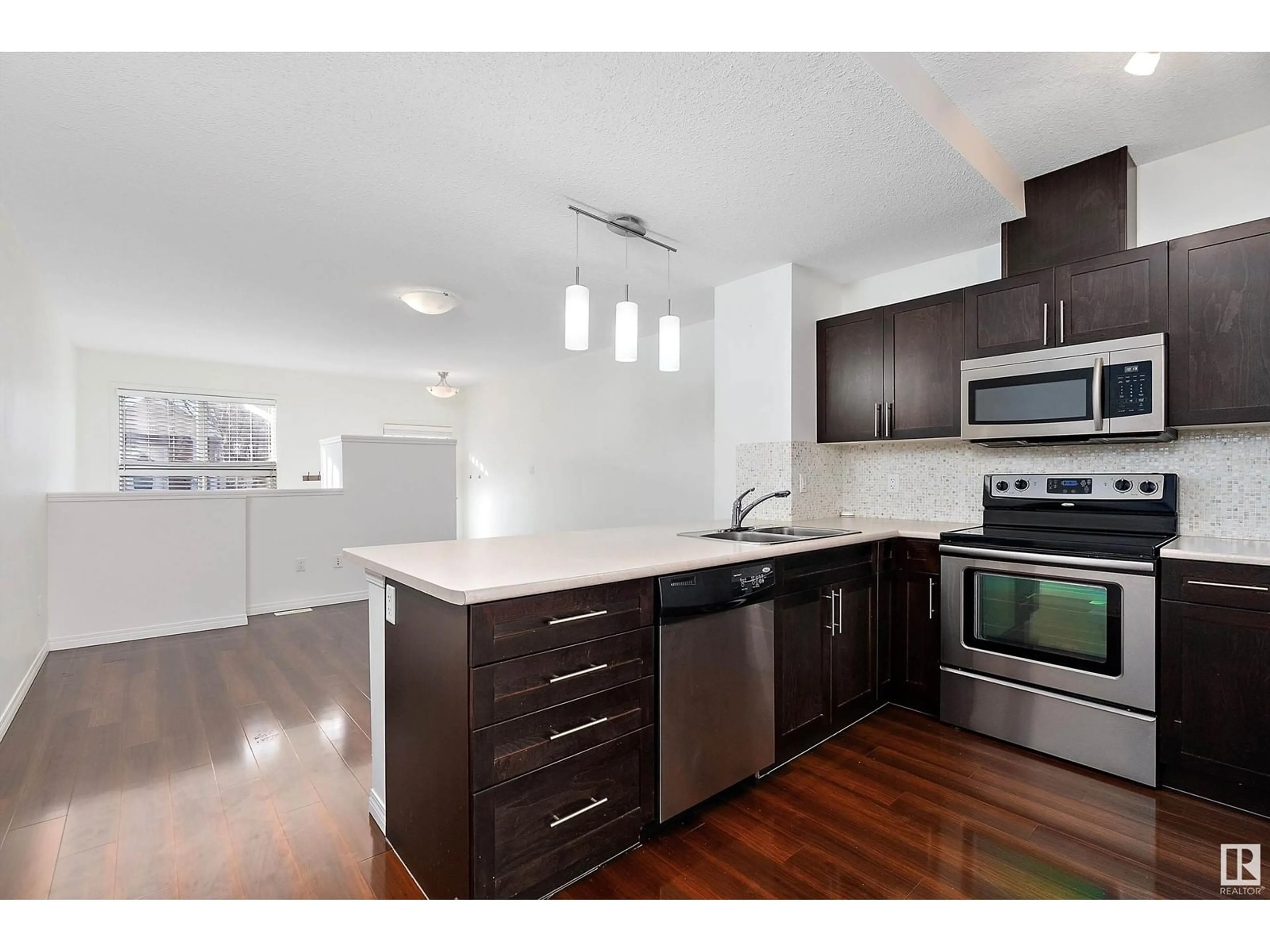 Open concept kitchen, wood/laminate floor for #84 1623 TOWNE CENTRE BV NW, Edmonton Alberta T6R0S3