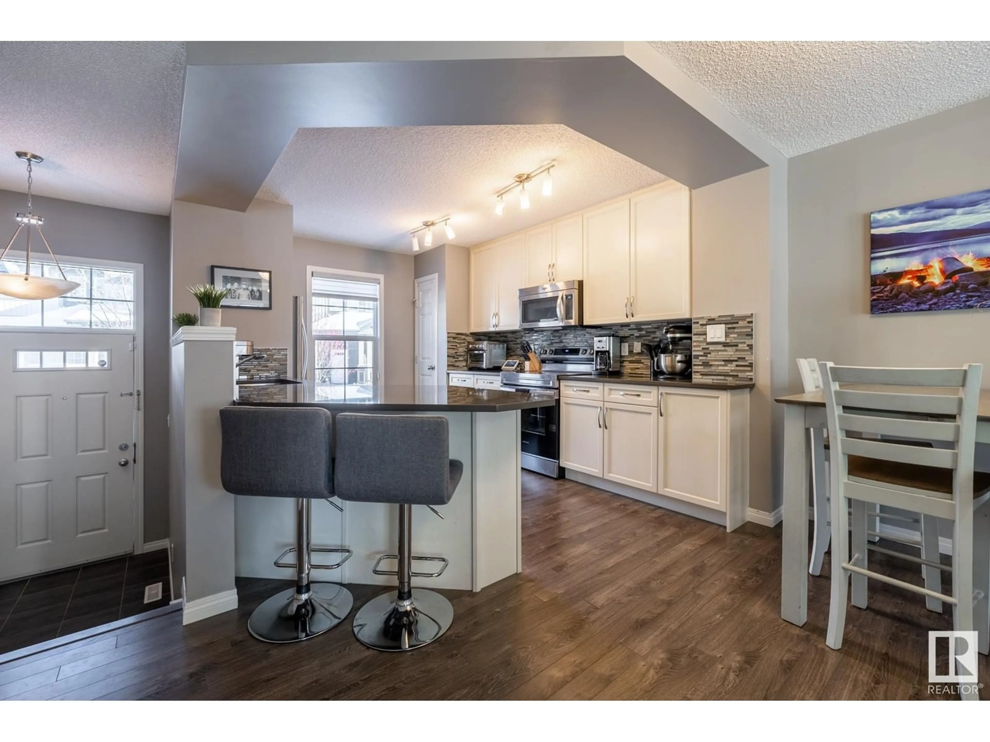 Open concept kitchen, wood/laminate floor for #34 4029 ORCHARDS DR SW, Edmonton Alberta T6X1V2