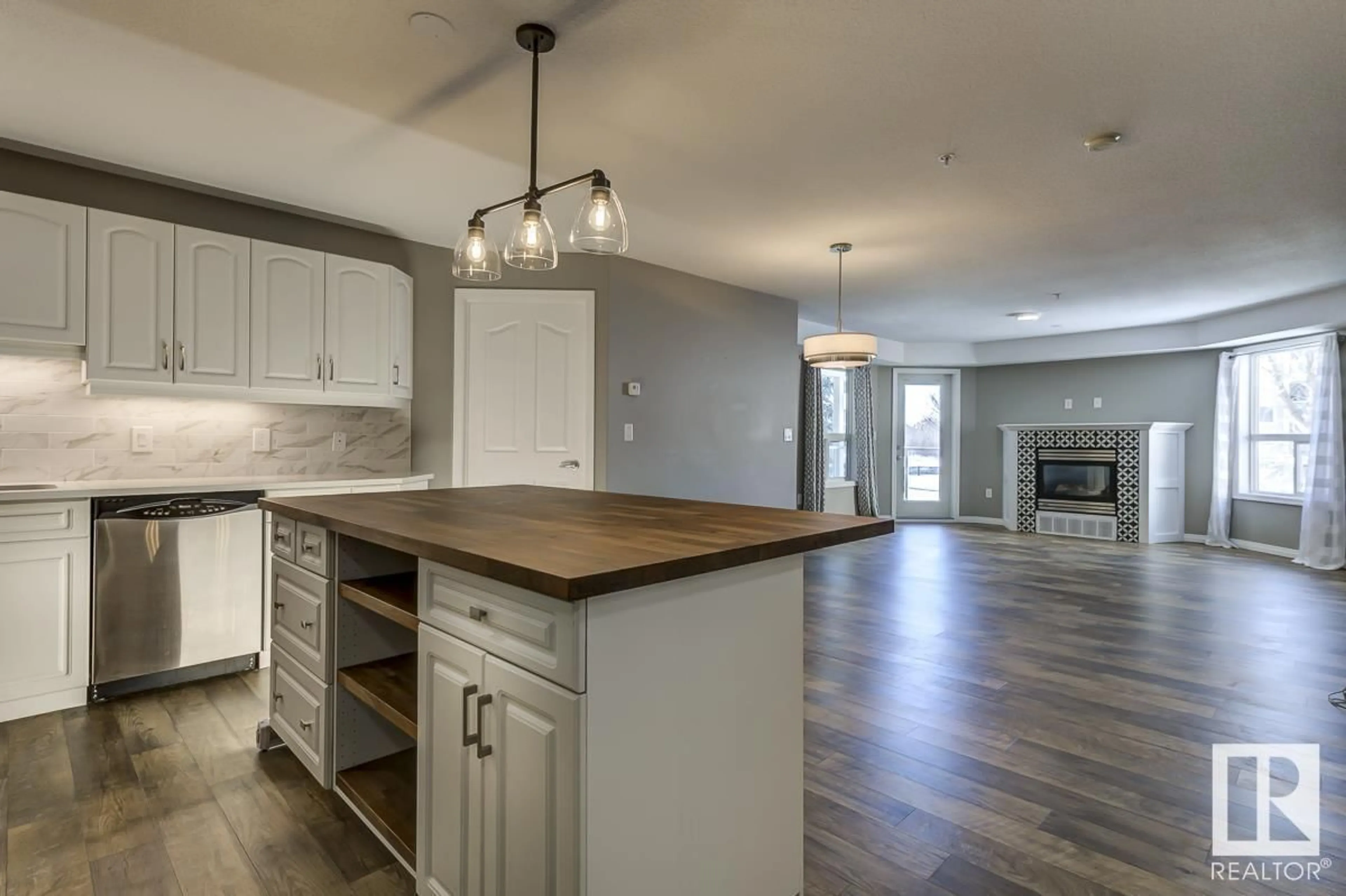 Open concept kitchen, wood/laminate floor for #203 9008 99 AV NW, Edmonton Alberta T5H4M6