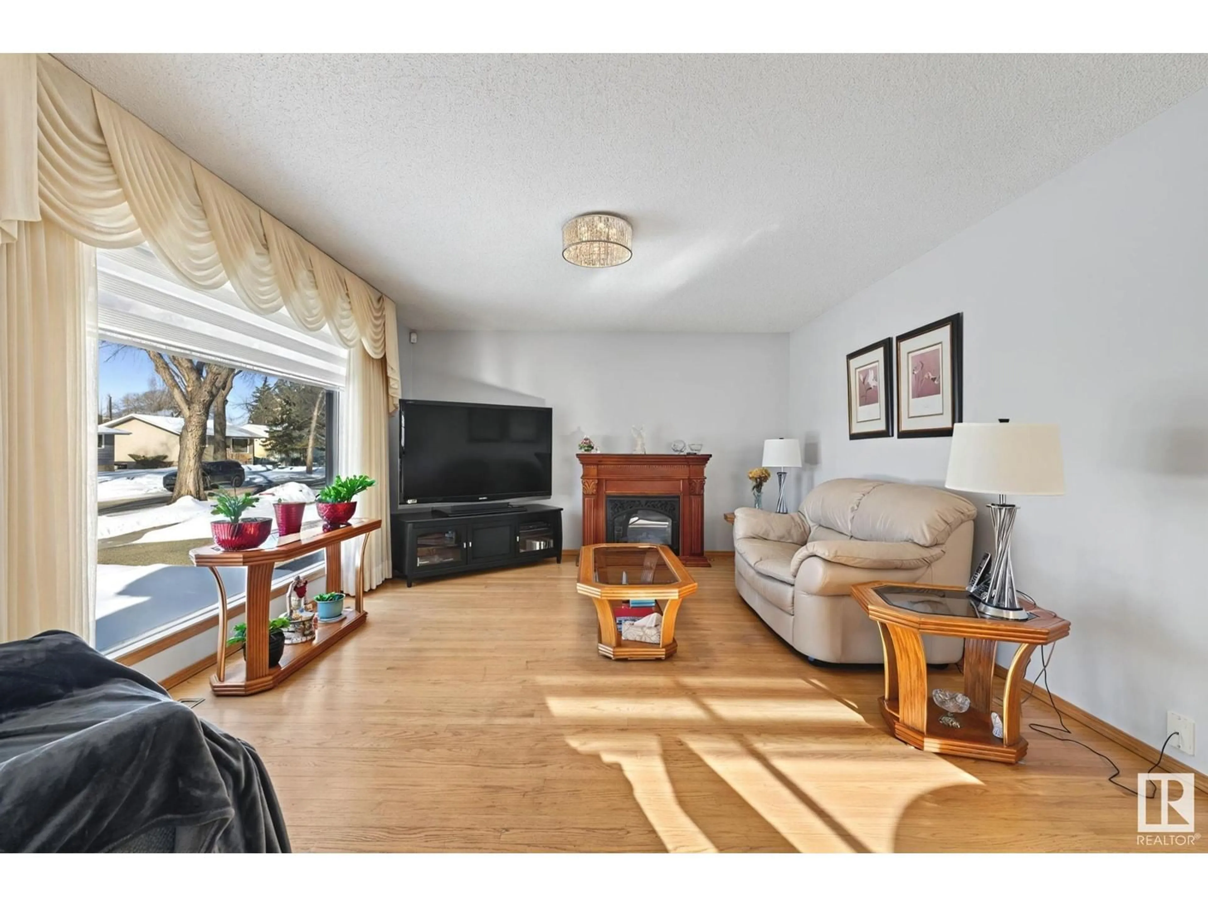 Living room with furniture, wood/laminate floor for 12323 128 ST NW, Edmonton Alberta T5L1C6