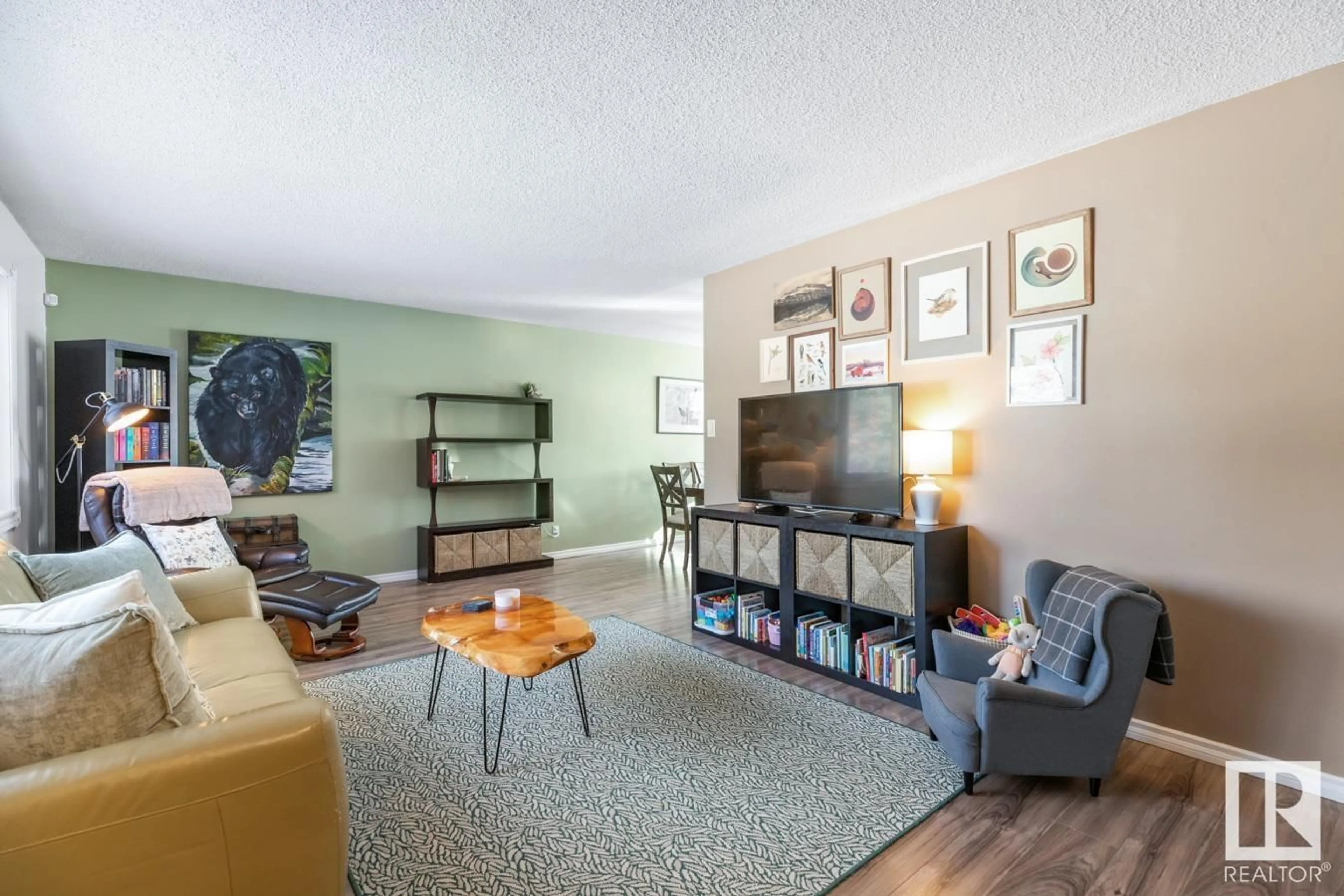 Living room with furniture, wood/laminate floor for 9531 81 ST NW, Edmonton Alberta T6C2W4