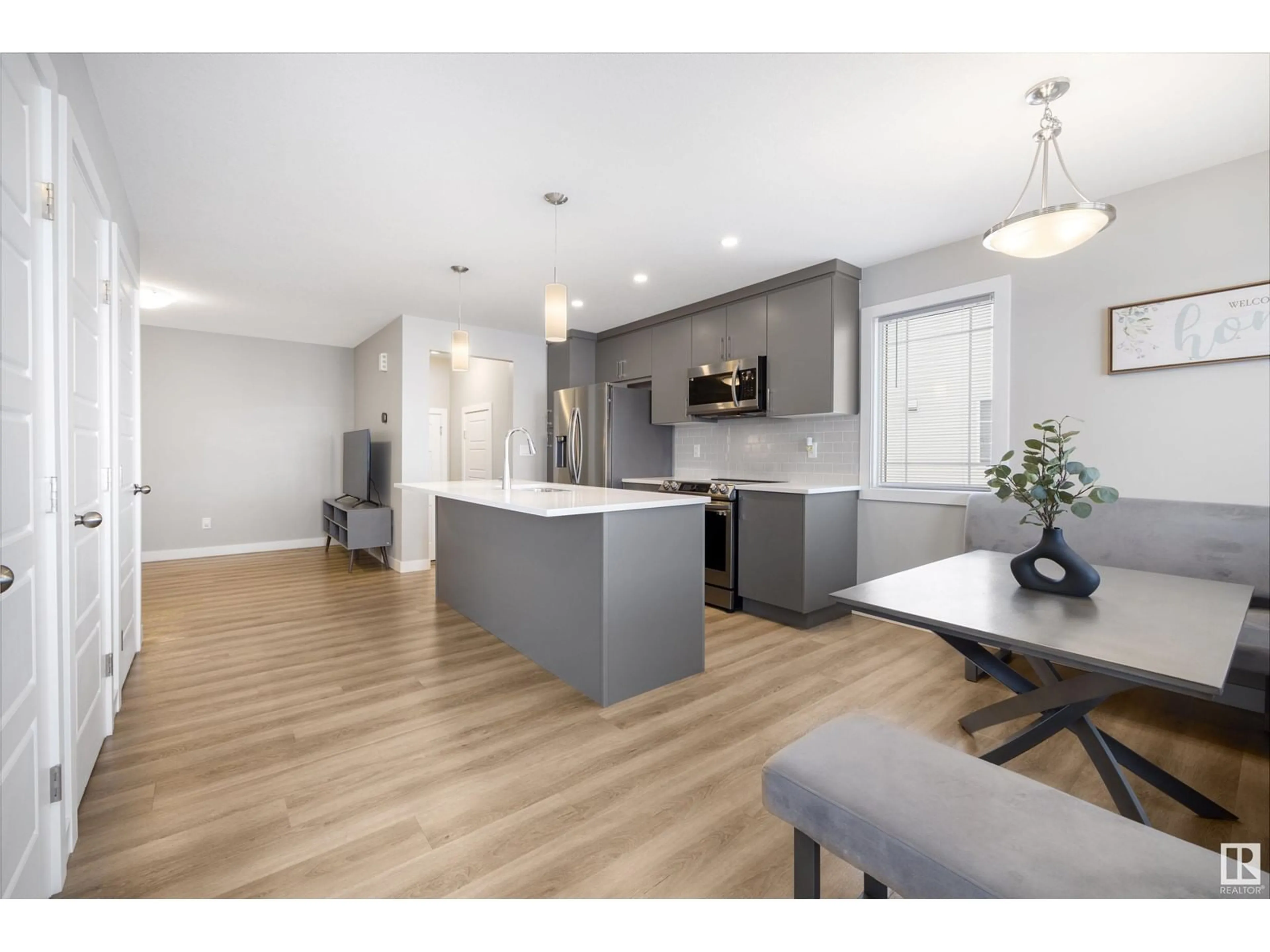 Open concept kitchen, wood/laminate floor for 994 STILLWATER BV NW, Edmonton Alberta T6M1M8