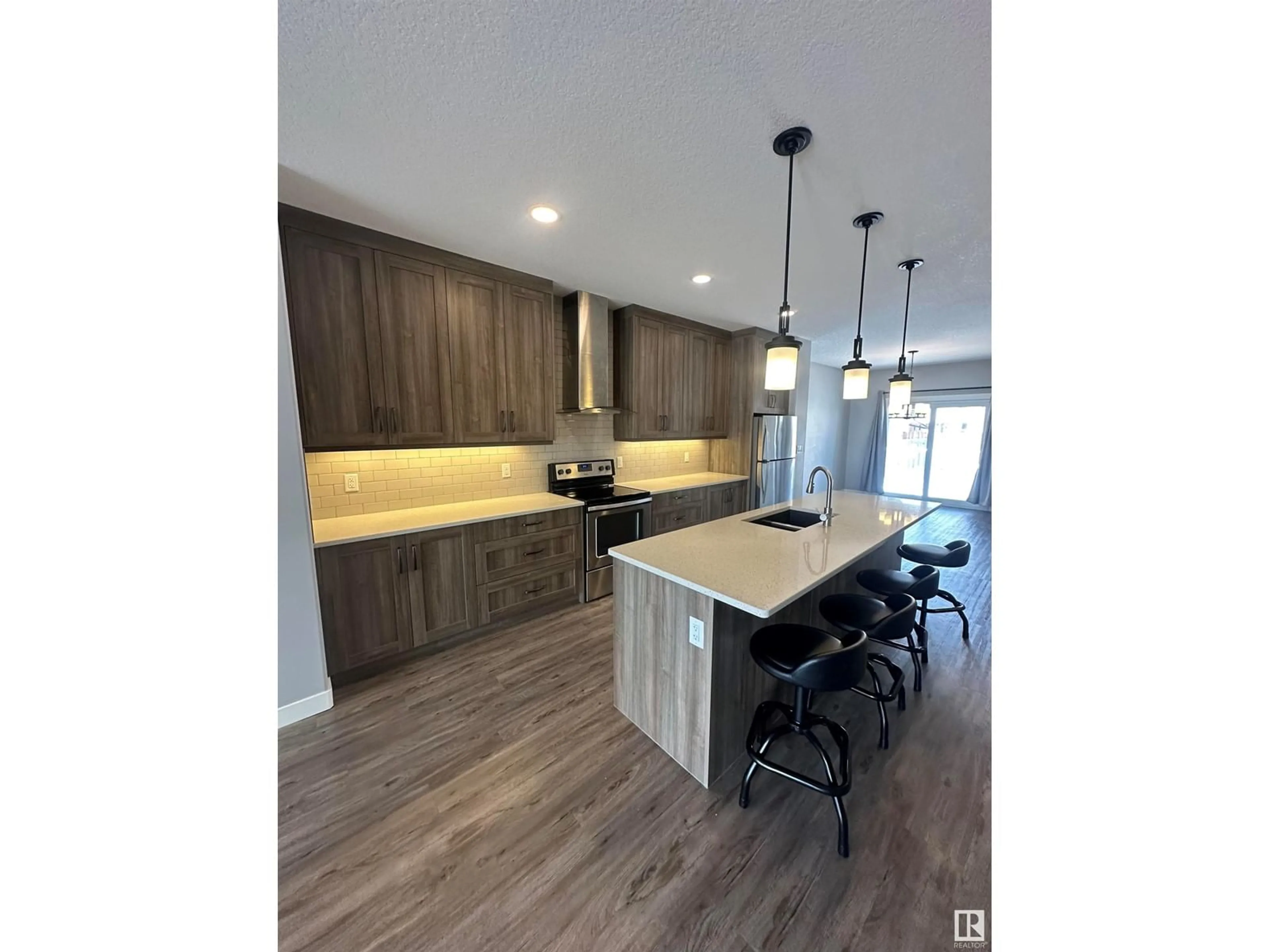 Open concept kitchen, wood/laminate floor for 8540 89 ST NW, Edmonton Alberta T6C3K3