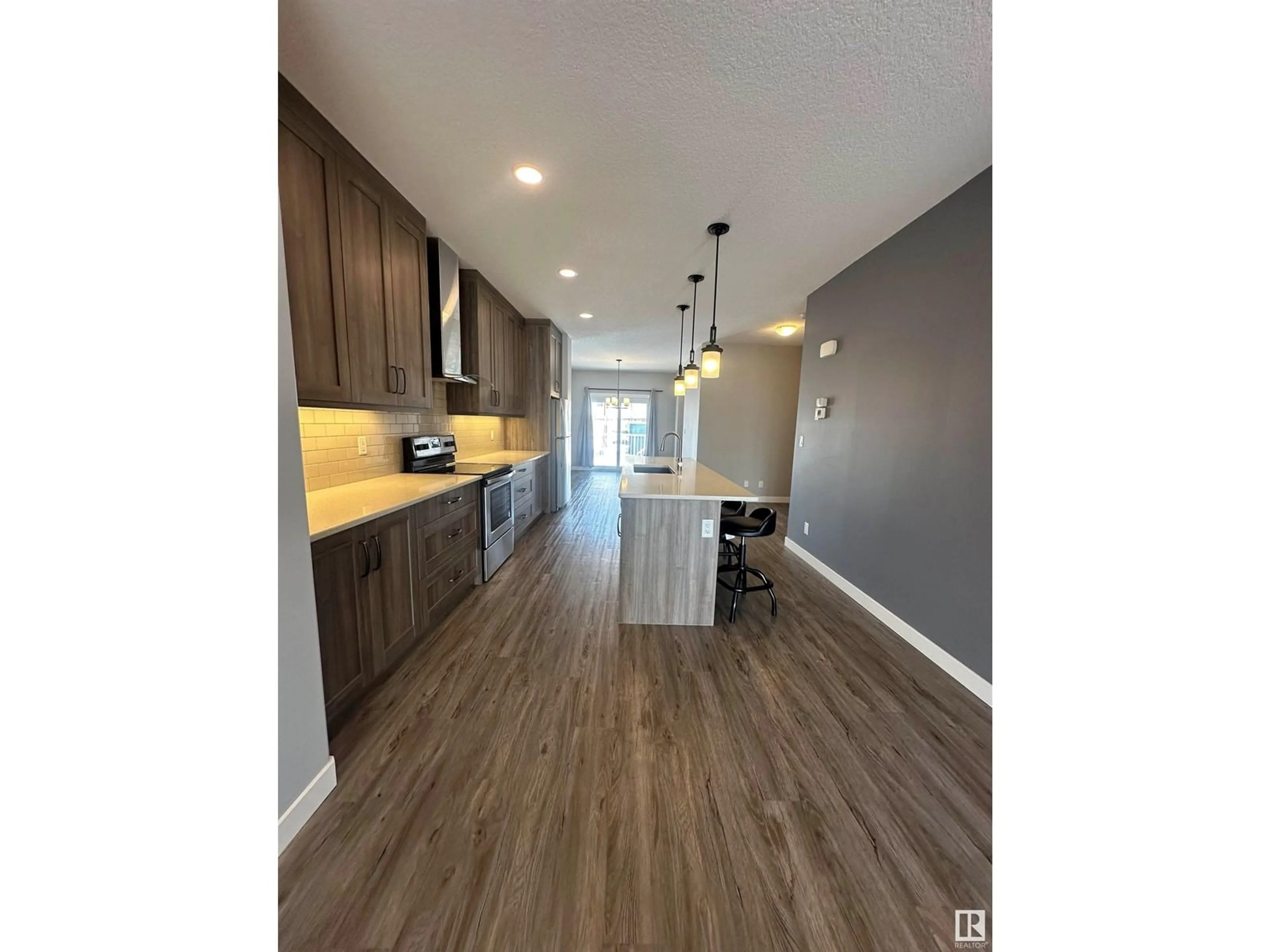 Open concept kitchen, wood/laminate floor for 8540 89 ST NW, Edmonton Alberta T6C3K3