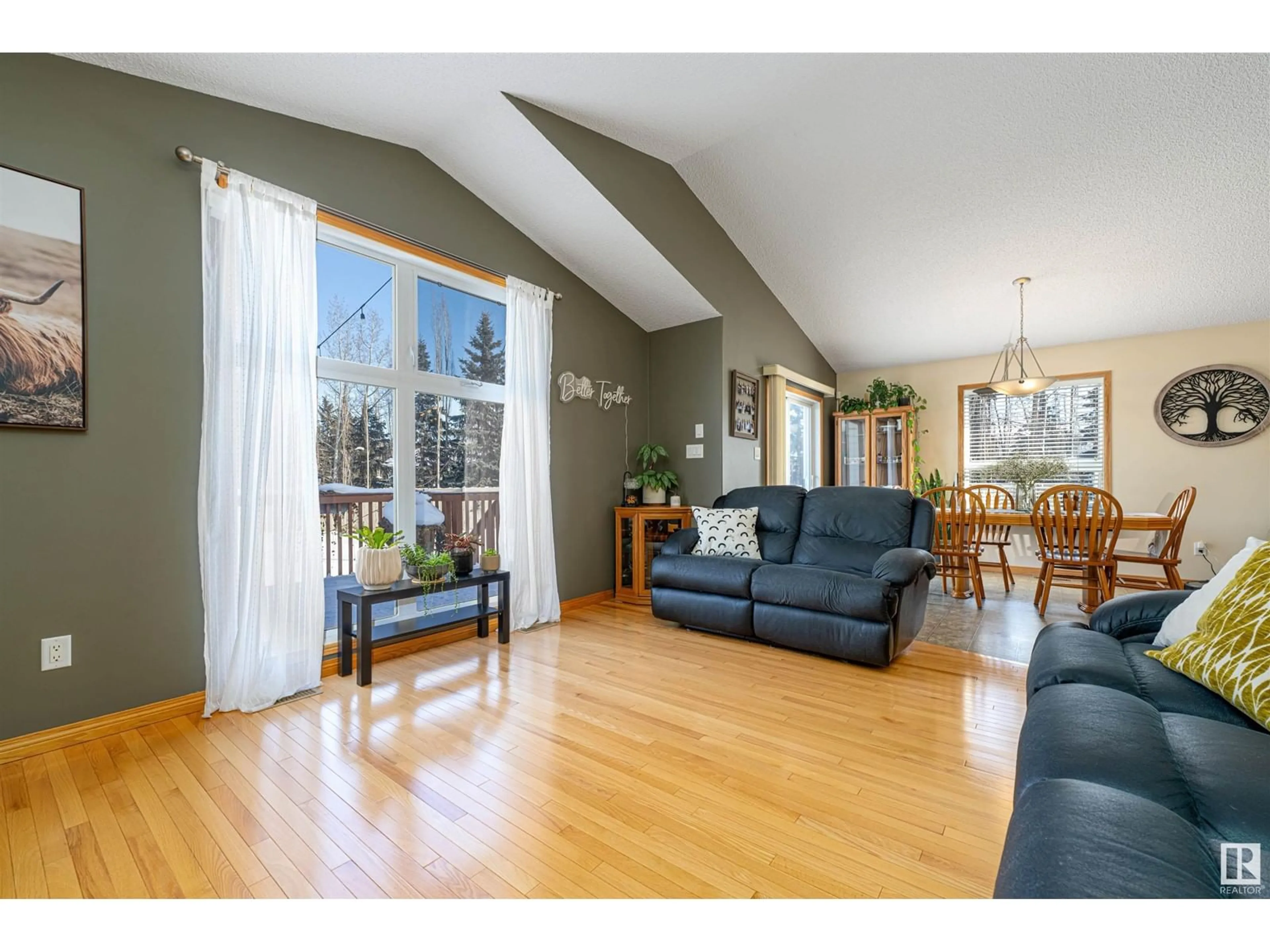 Living room with furniture, wood/laminate floor for 7708 7A AV SW, Edmonton Alberta T6X0A2