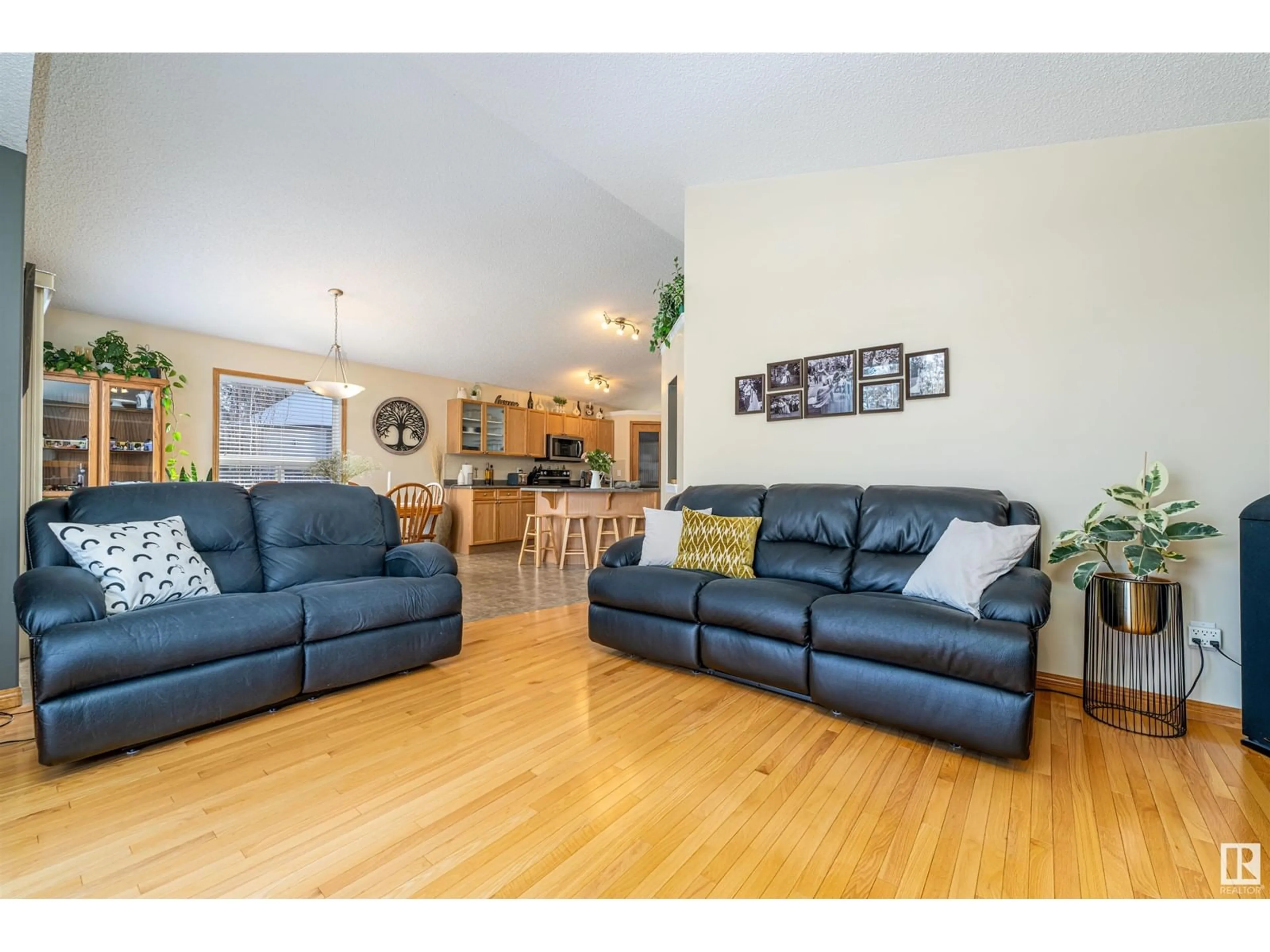 Living room with furniture, wood/laminate floor for 7708 7A AV SW, Edmonton Alberta T6X0A2