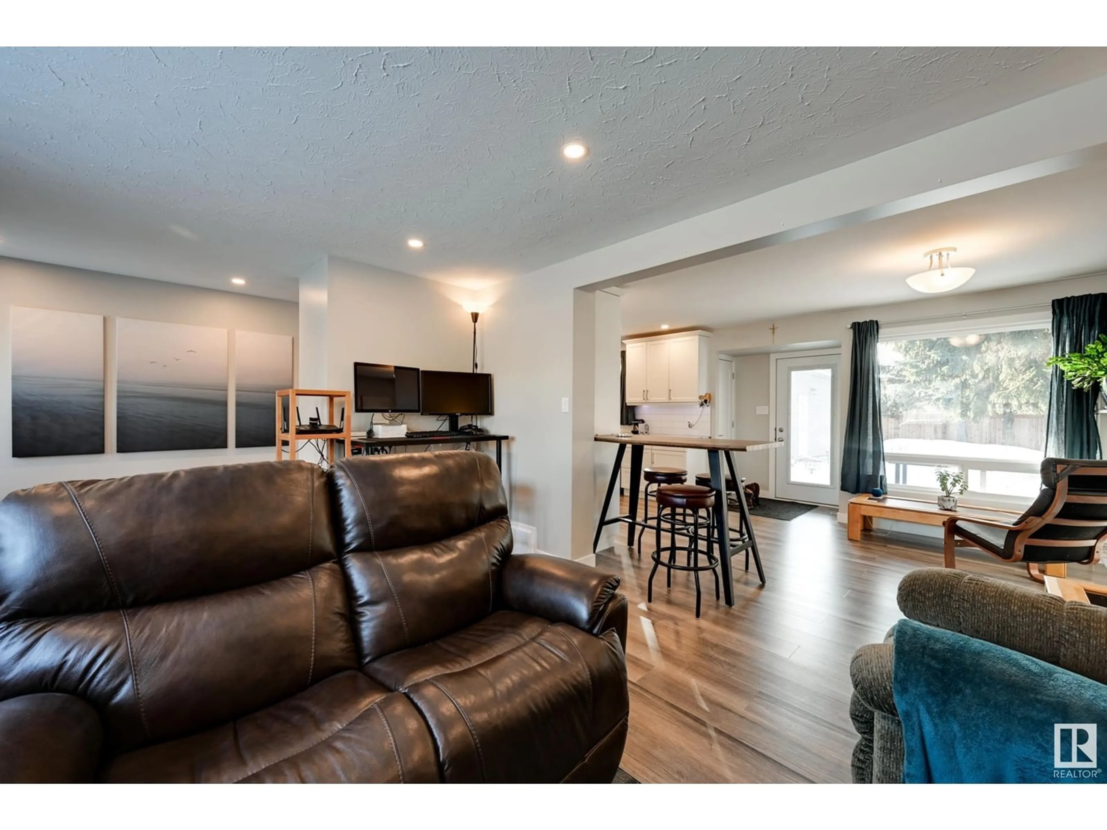 Living room with furniture, wood/laminate floor for 10931 137 AV NW, Edmonton Alberta T5E1Z2