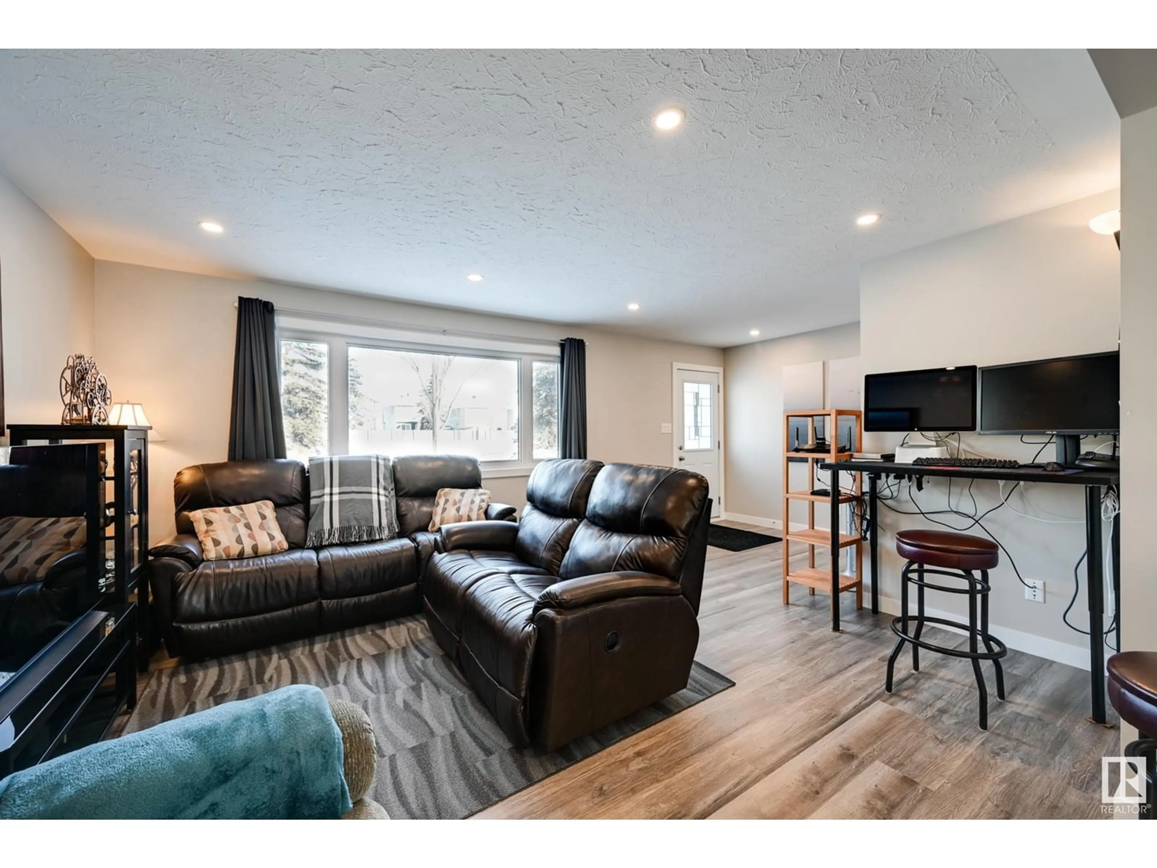 Living room with furniture, wood/laminate floor for 10931 137 AV NW, Edmonton Alberta T5E1Z2