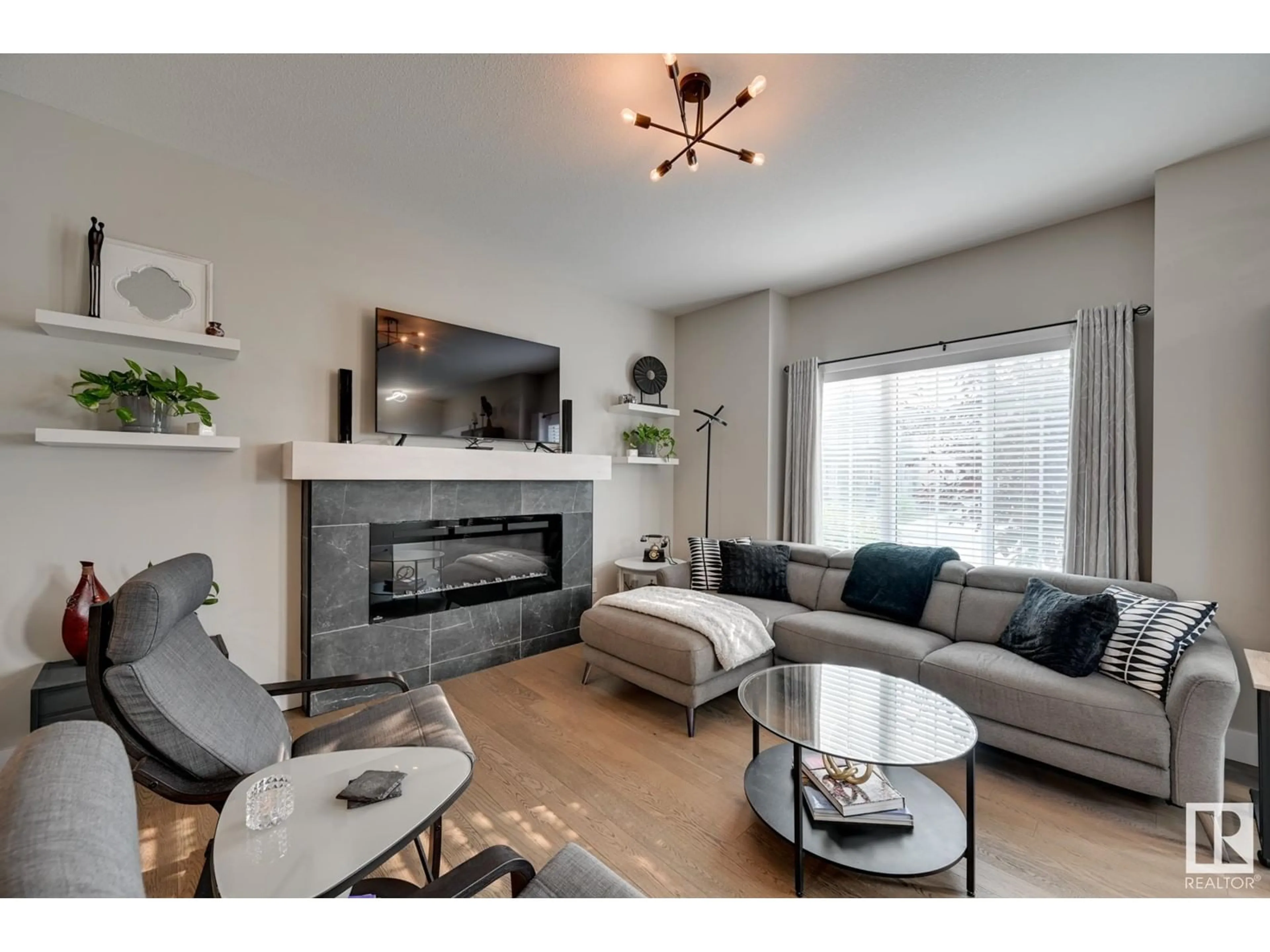 Living room with furniture, wood/laminate floor for 3144 KESWICK WY SW, Edmonton Alberta T6W0S5