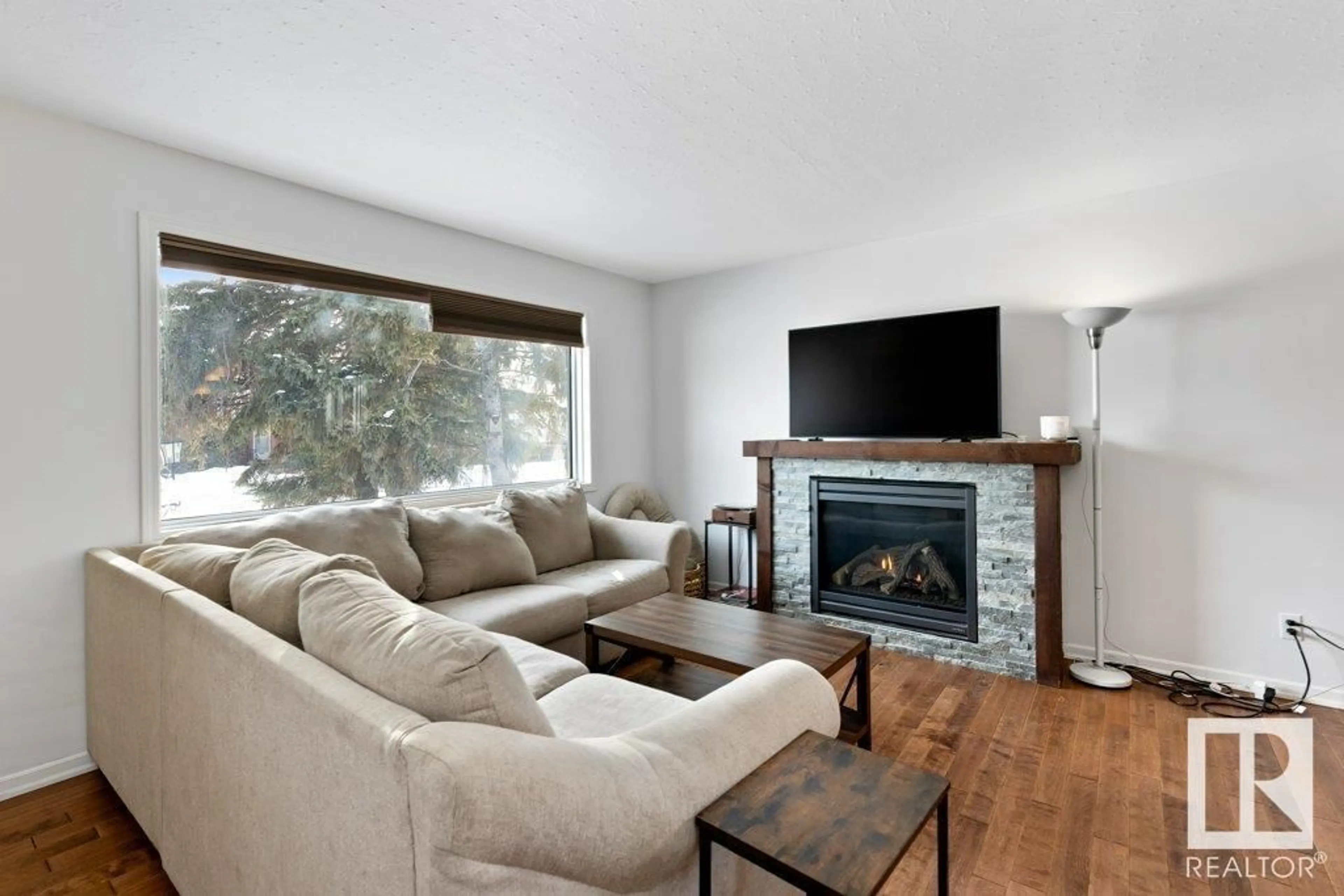 Living room with furniture, wood/laminate floor for 13608 135A AV NW, Edmonton Alberta T5L3Z9