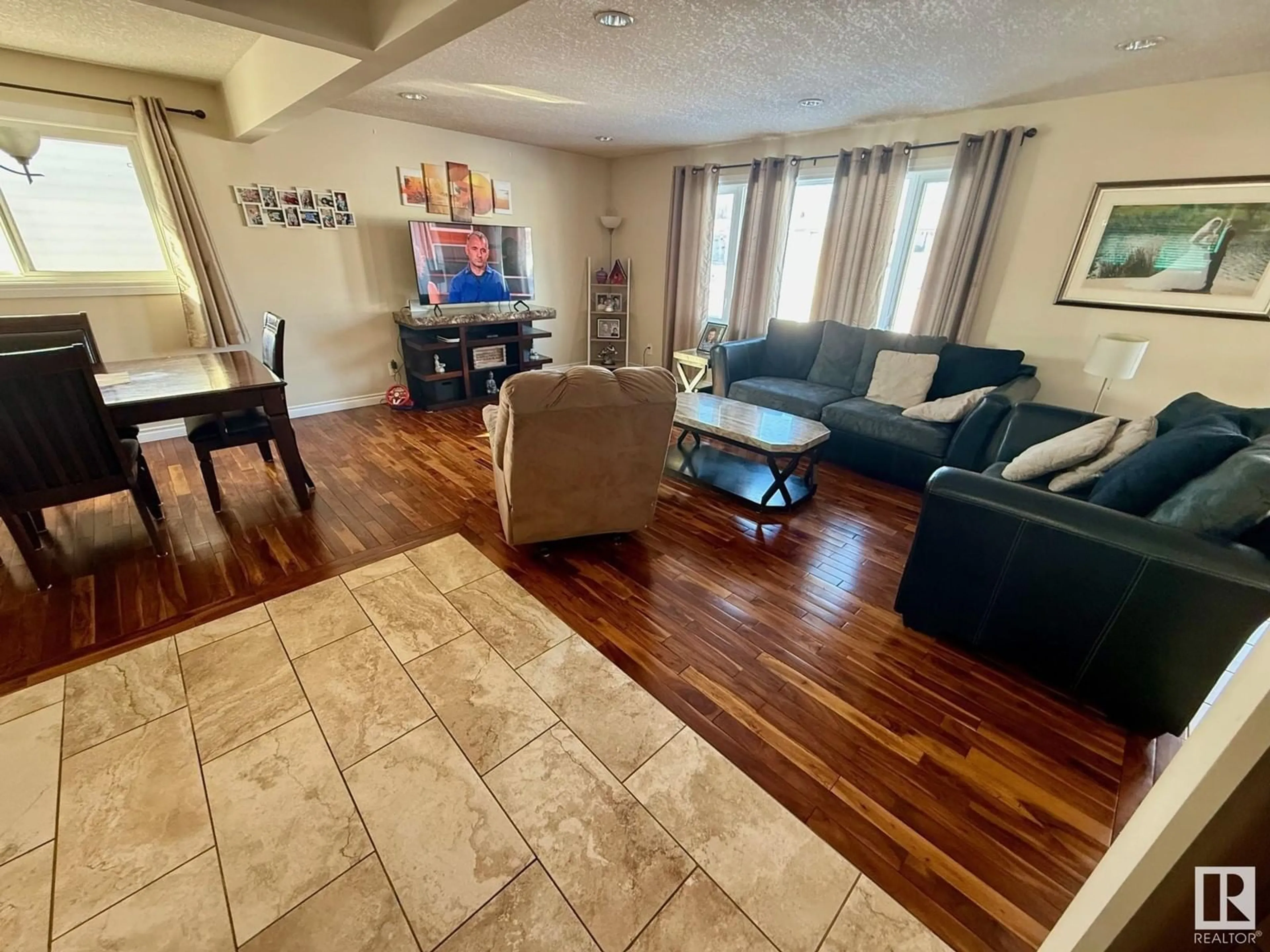 Living room with furniture, wood/laminate floor for 7207 140 AV NW, Edmonton Alberta T5C2M6