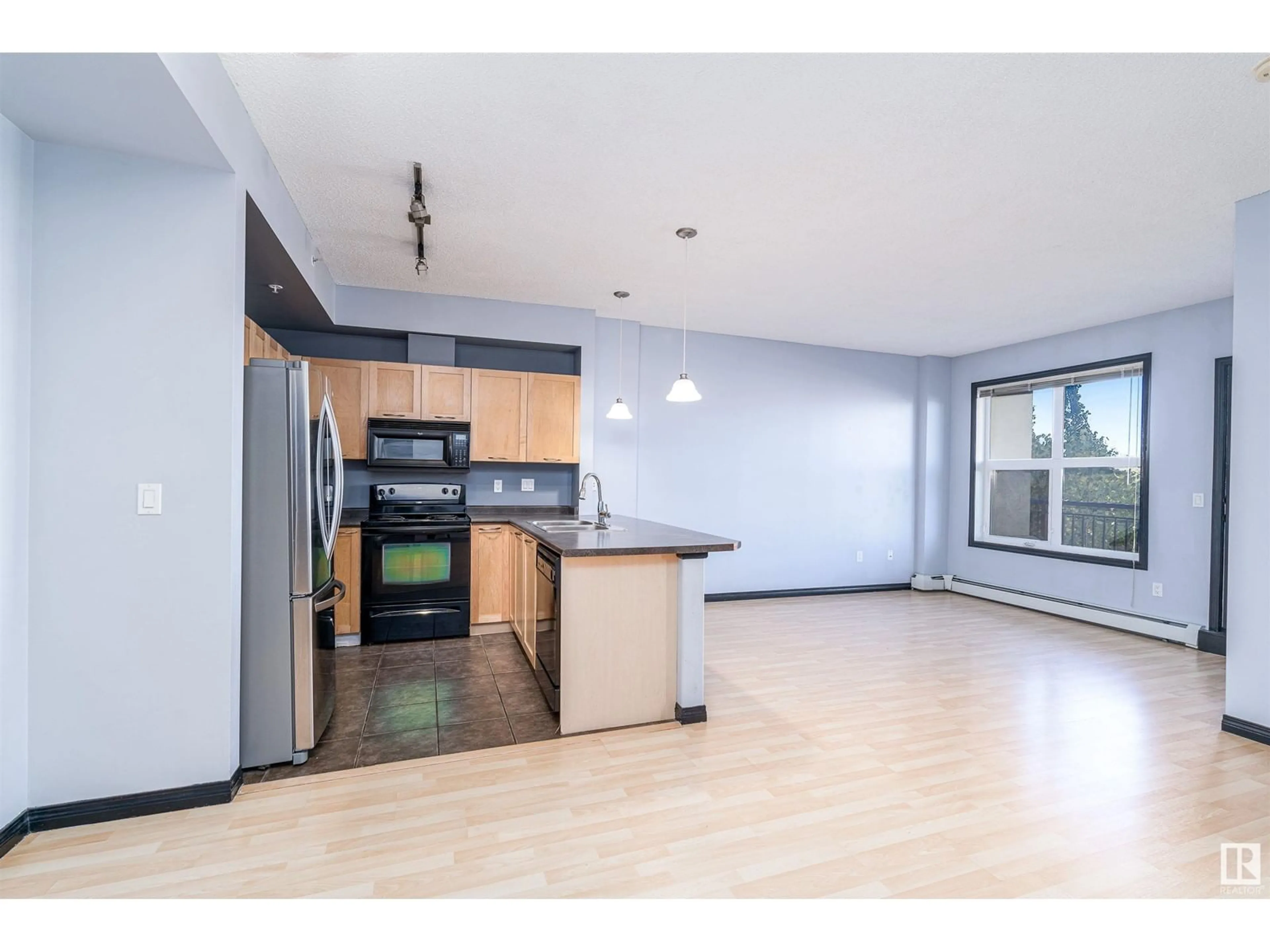 Open concept kitchen, wood/laminate floor for #1-307 - 4245 139 AV, Edmonton Alberta T5Y3E8