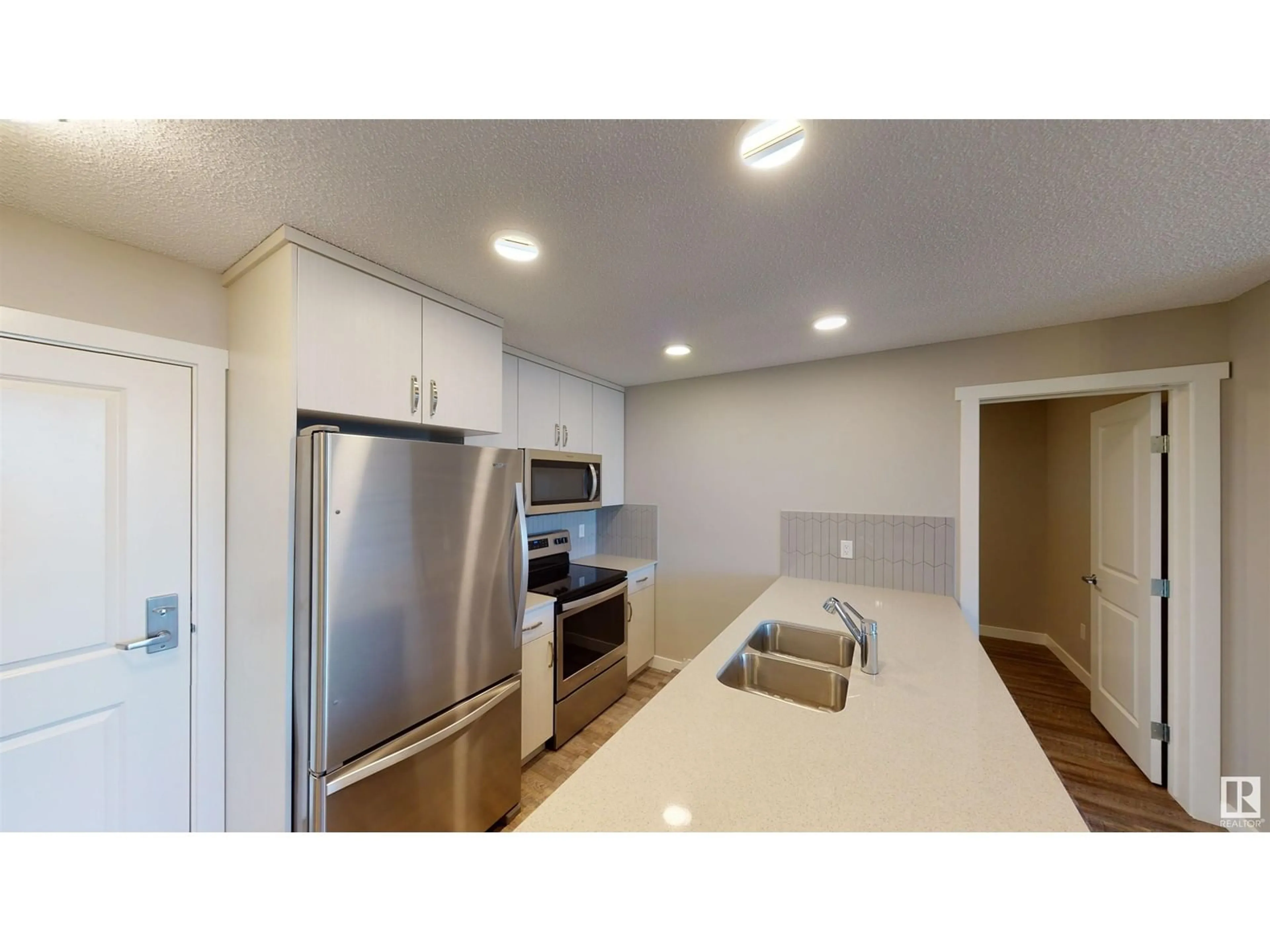 Open concept kitchen, unknown for #121 1506 tamarack BV NW, Edmonton Alberta T6T2E3