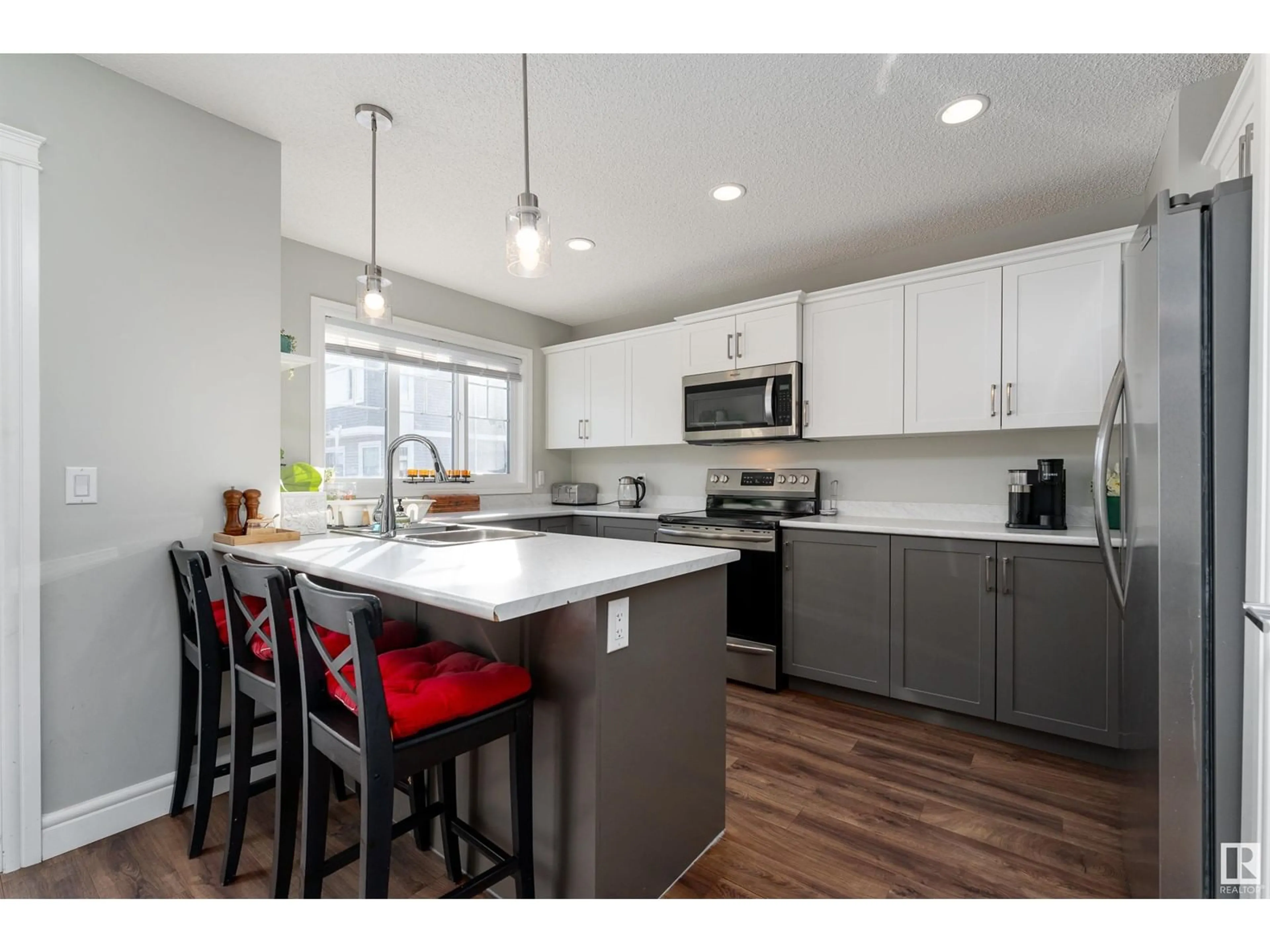 Open concept kitchen, wood/laminate floor for #18 1391 STARLING DR NW, Edmonton Alberta T5S0L3