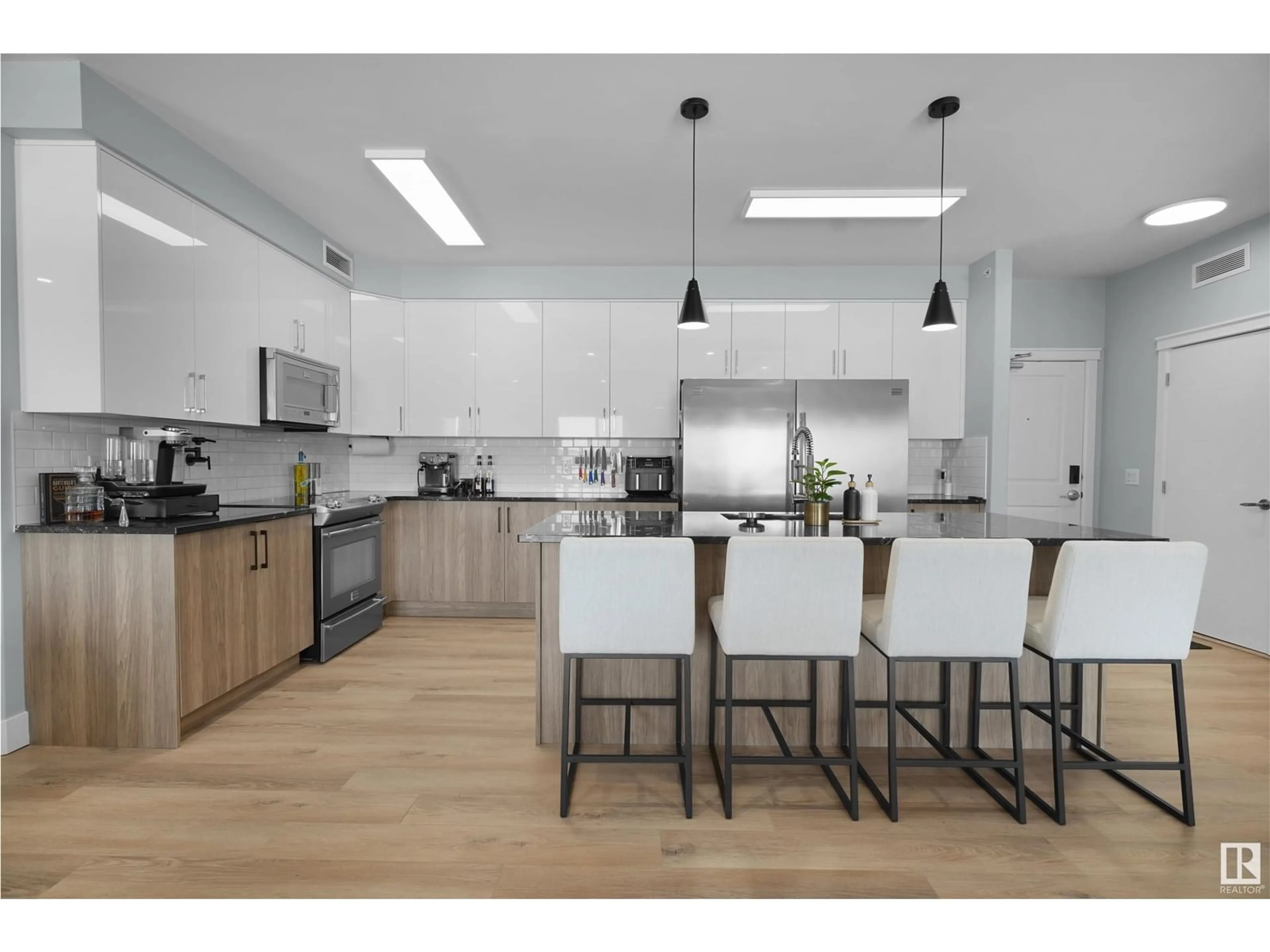 Open concept kitchen, wood/laminate floor for #410 - 3719 WHITELAW LN, Edmonton Alberta T6W2L3