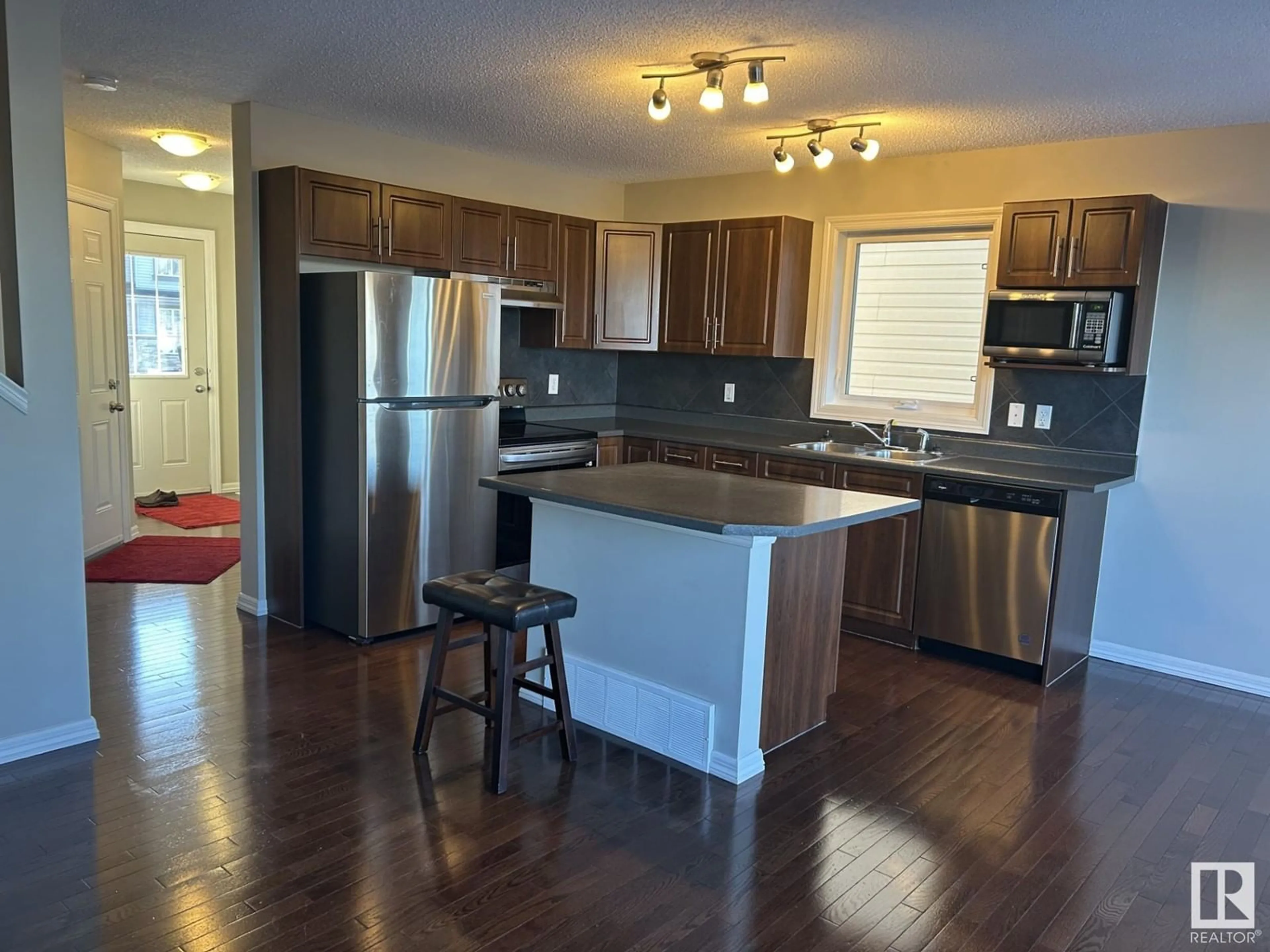 Open concept kitchen, wood/laminate floor for 5148 1A AV SW, Edmonton Alberta T6X0X3