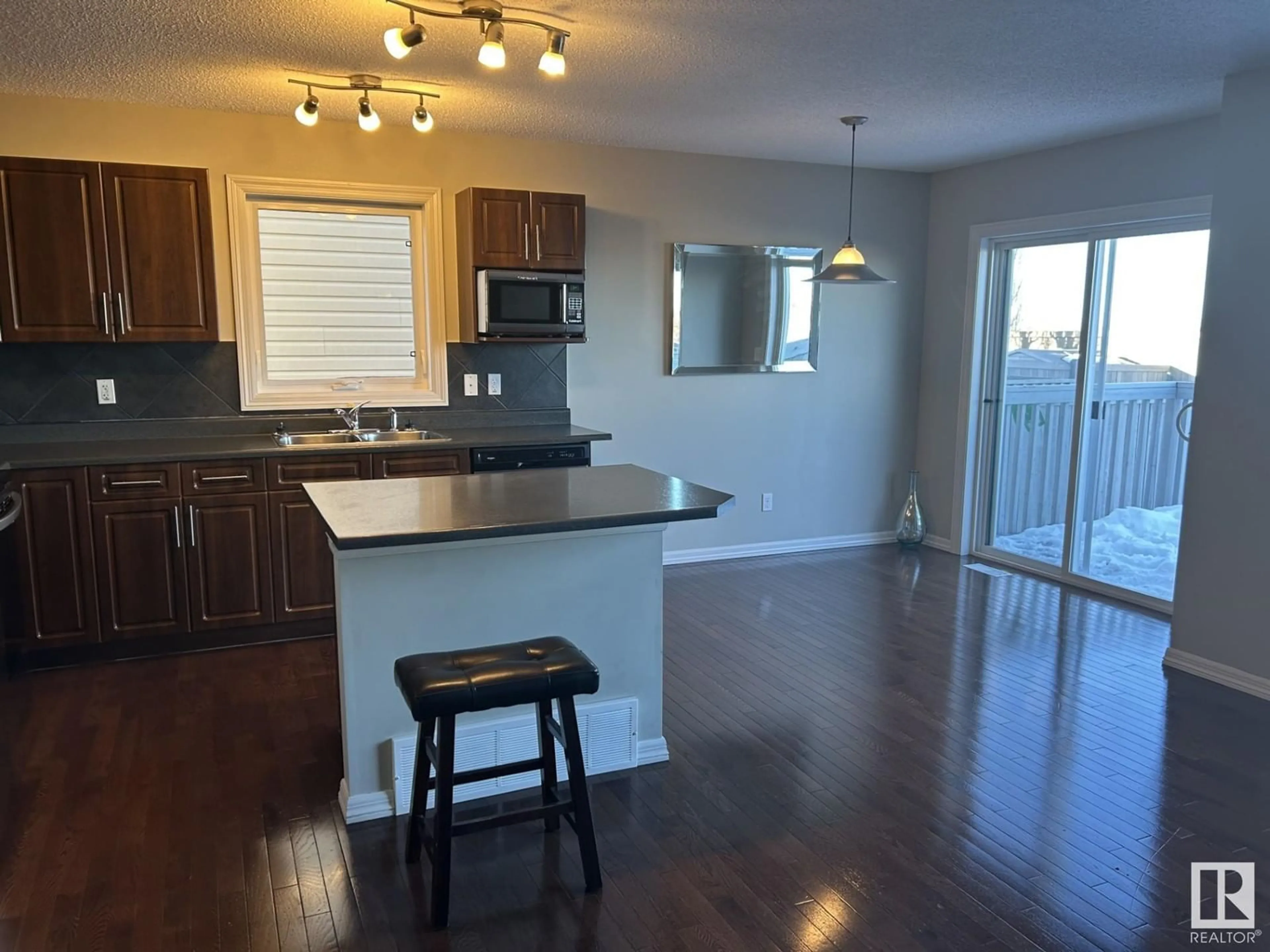 Open concept kitchen, wood/laminate floor for 5148 1A AV SW, Edmonton Alberta T6X0X3