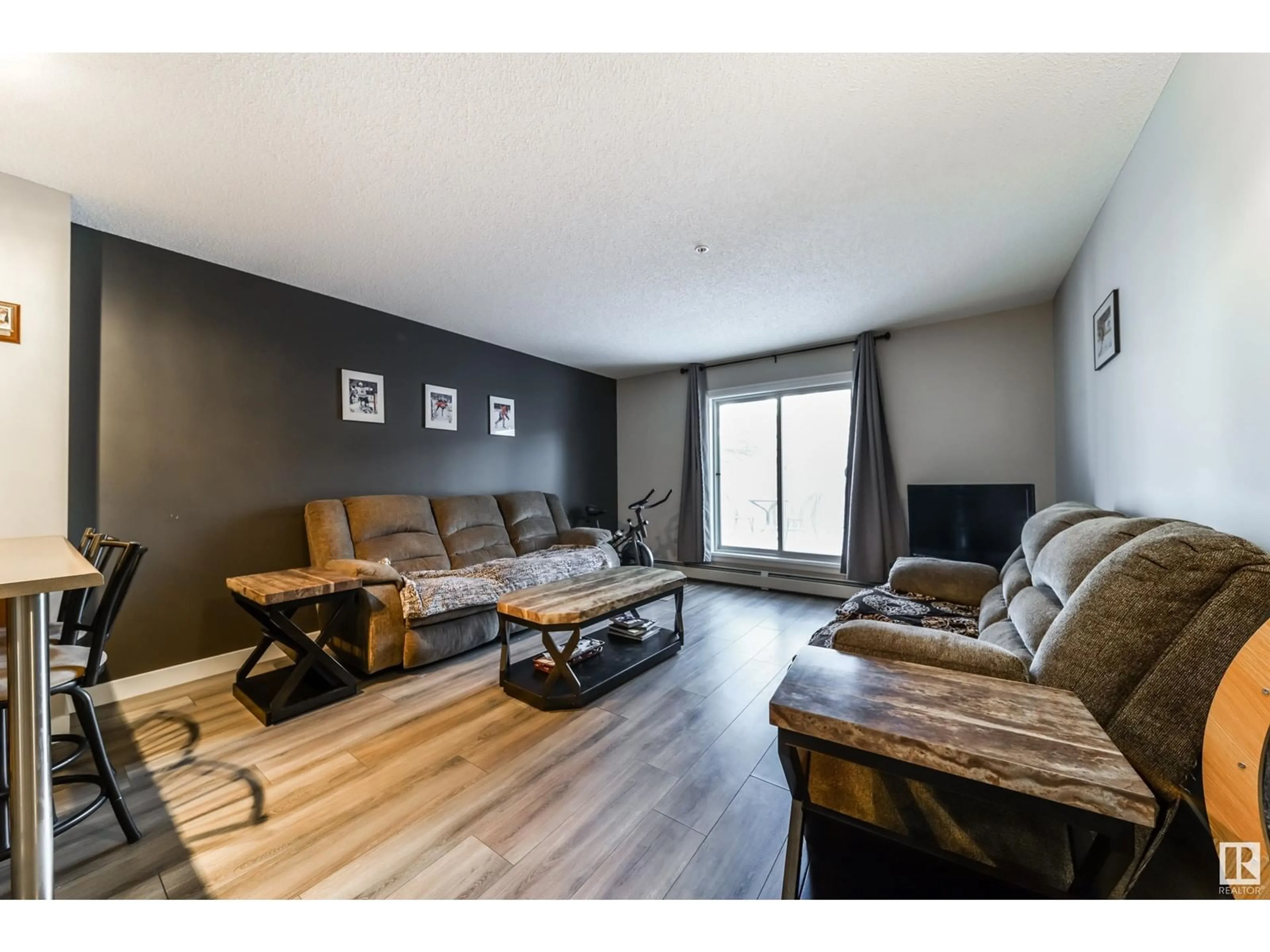 Living room with furniture, wood/laminate floor for #103 4407 23 ST NW, Edmonton Alberta T6T0B6