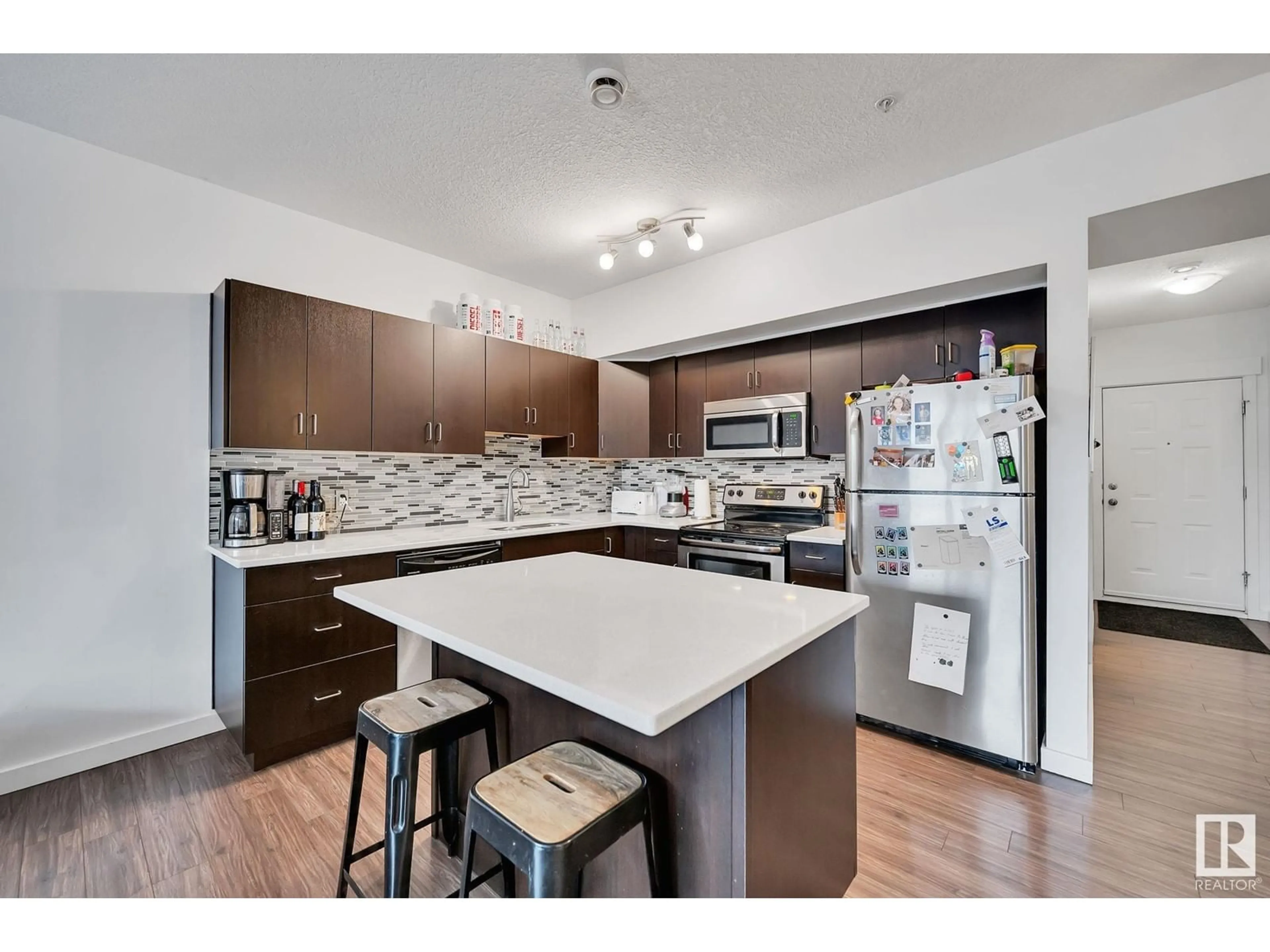 Open concept kitchen, wood/laminate floor for #109 10518 113 ST NW NW, Edmonton Alberta T5H0C6