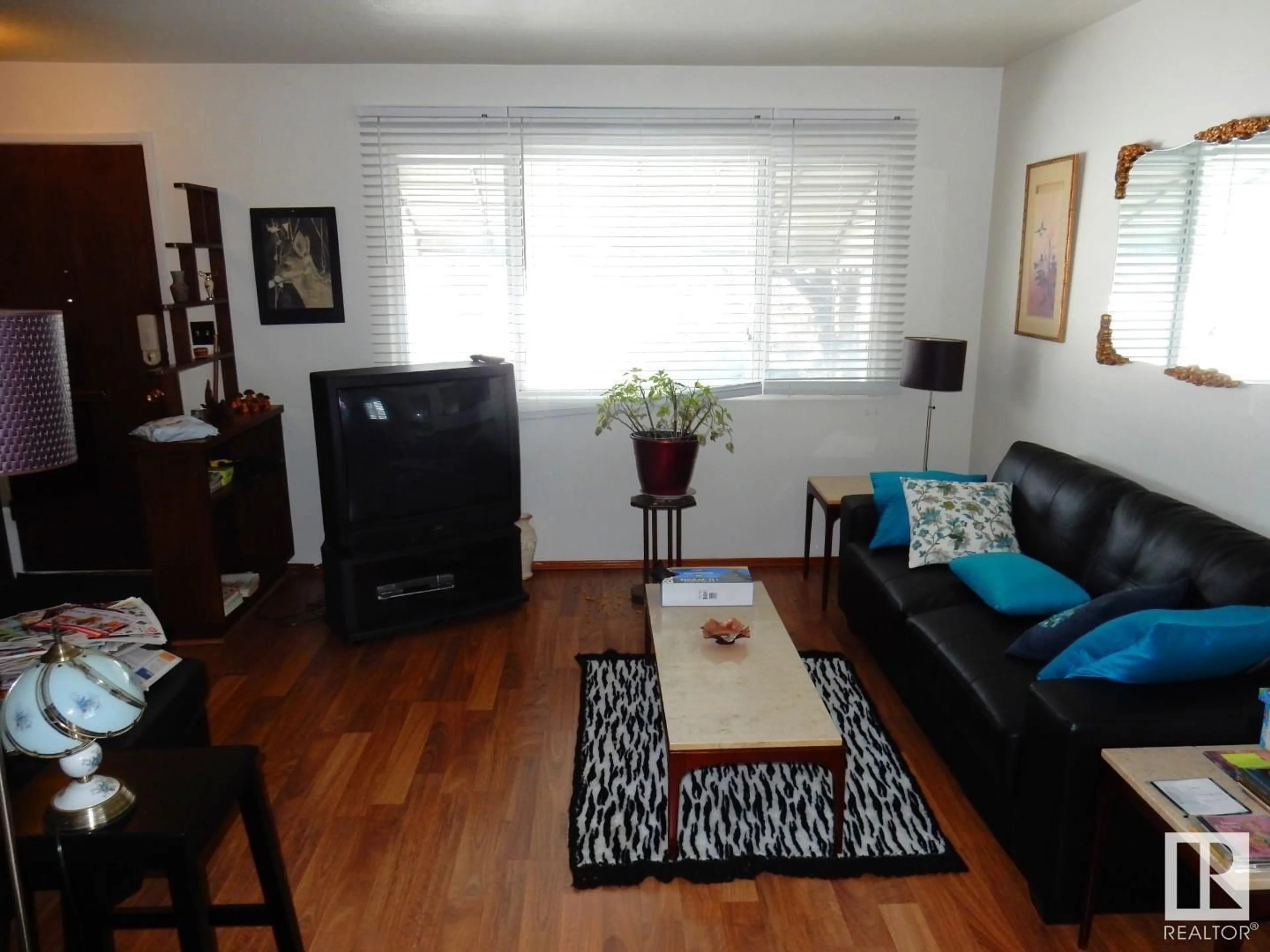 Living room with furniture, wood/laminate floor for 10407 50 ST NW, Edmonton Alberta T6A2C3