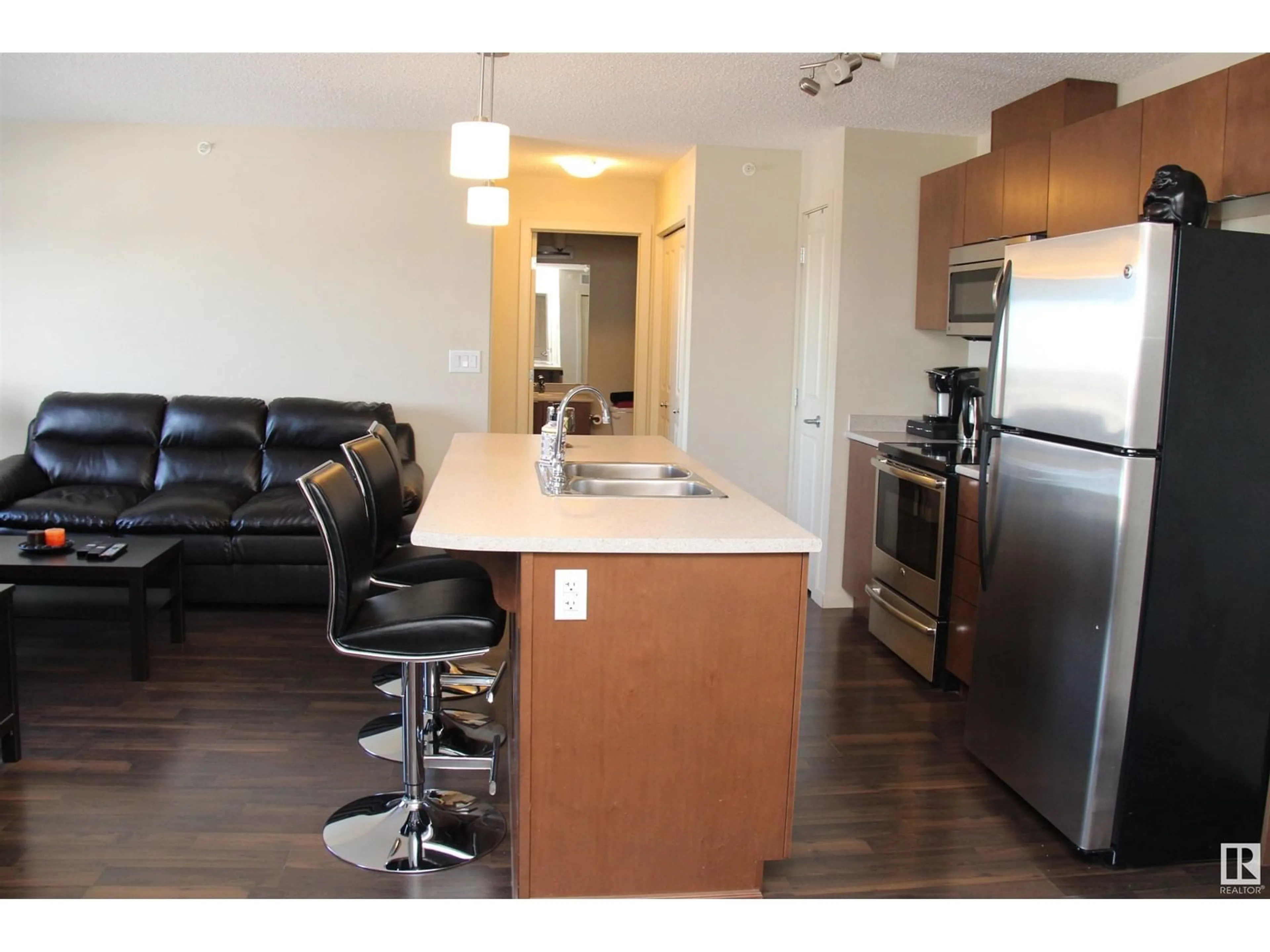 Open concept kitchen, wood/laminate floor for #417 3357 16A AV NW, Edmonton Alberta T6T0V4