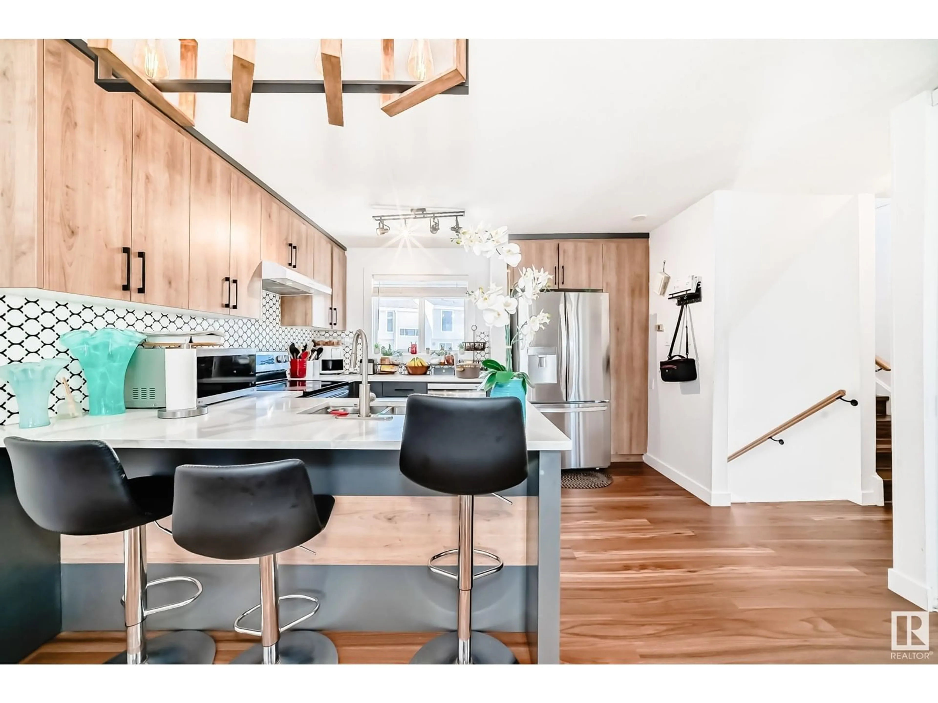 Open concept kitchen, wood/laminate floor for 5507 144A AV, Edmonton Alberta T5A3R2