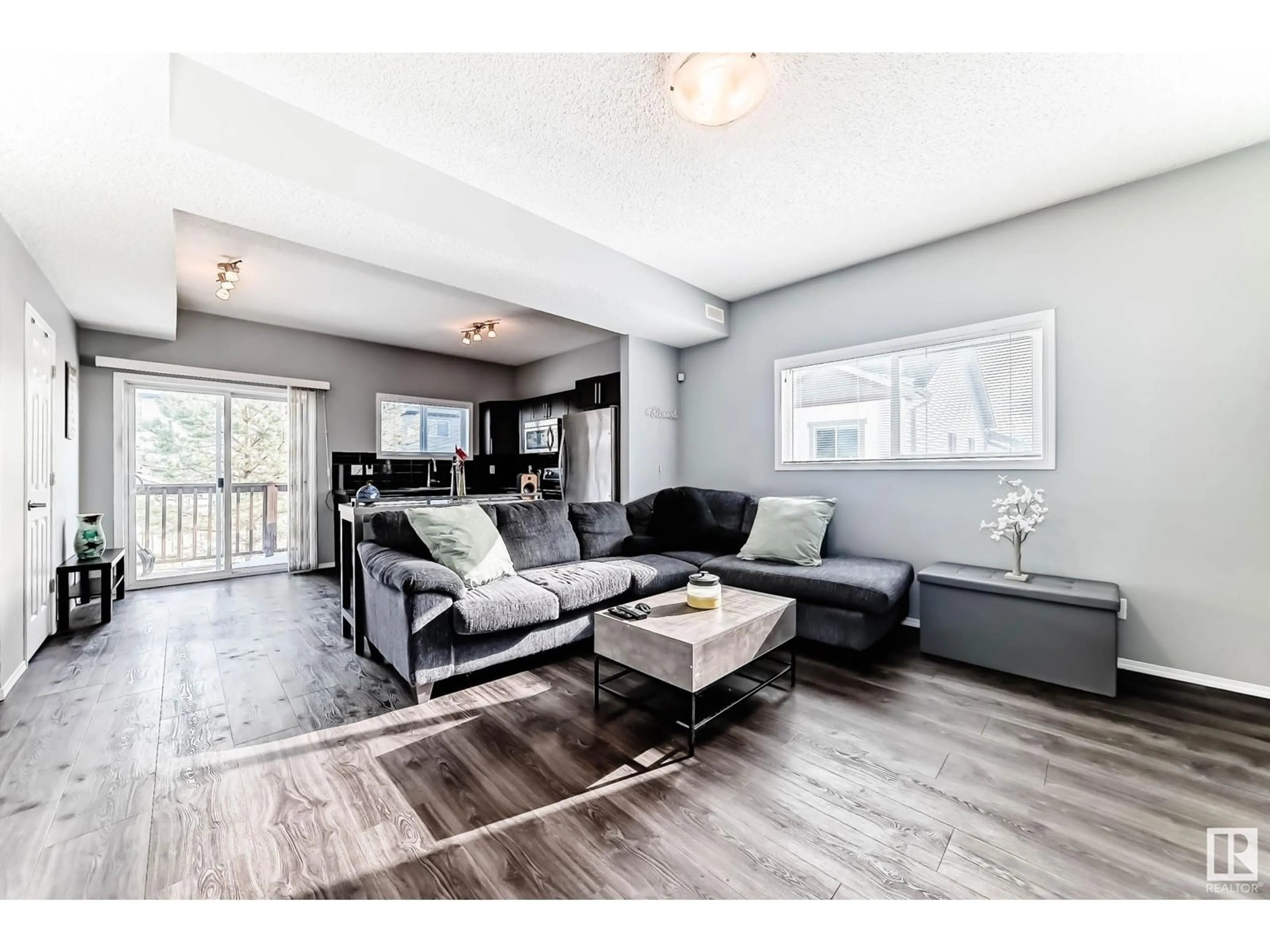 Living room with furniture, wood/laminate floor for #9 6520 2 AV SW, Edmonton Alberta T6X1S4