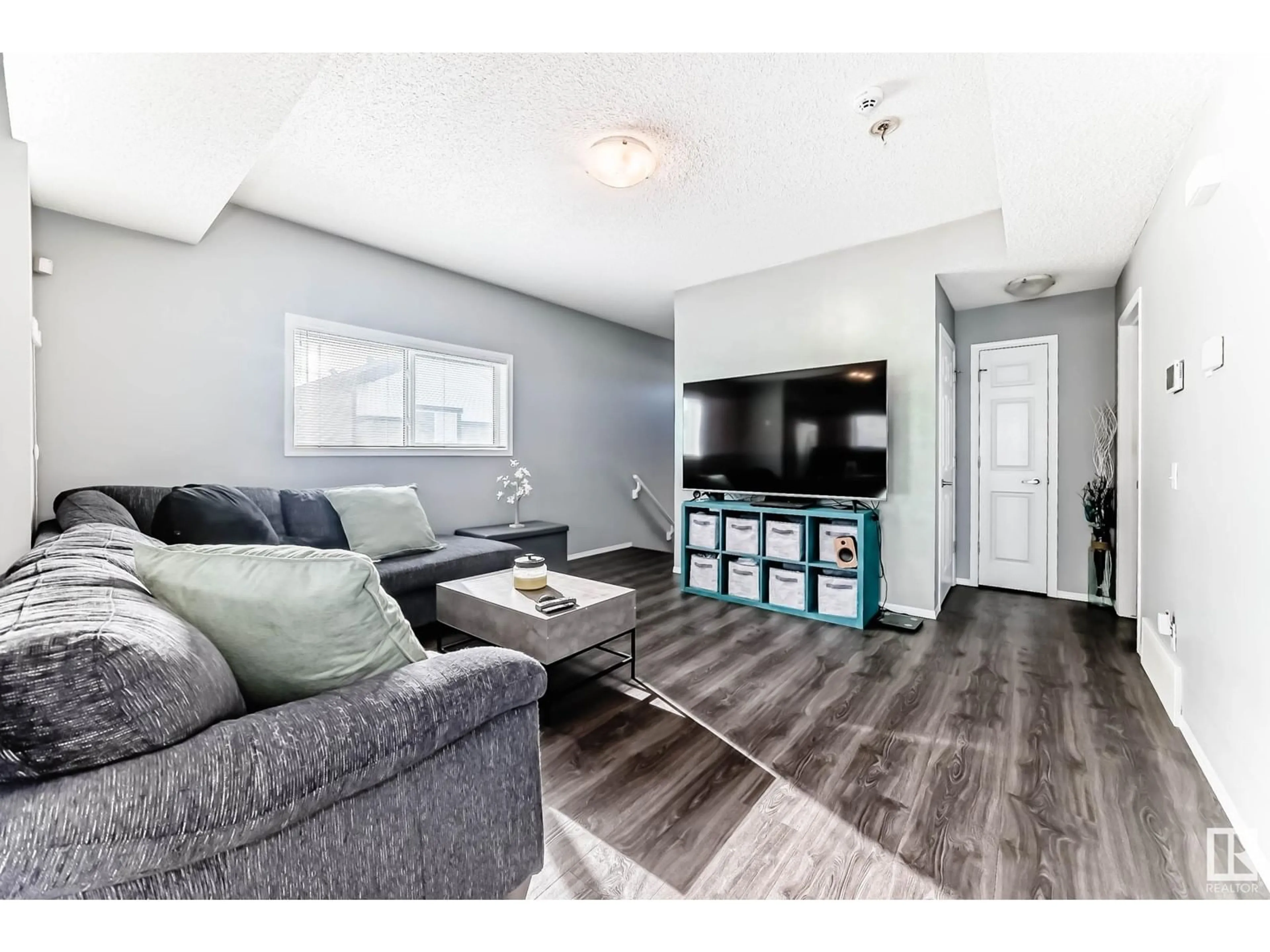 Living room with furniture, wood/laminate floor for #9 6520 2 AV SW, Edmonton Alberta T6X1S4