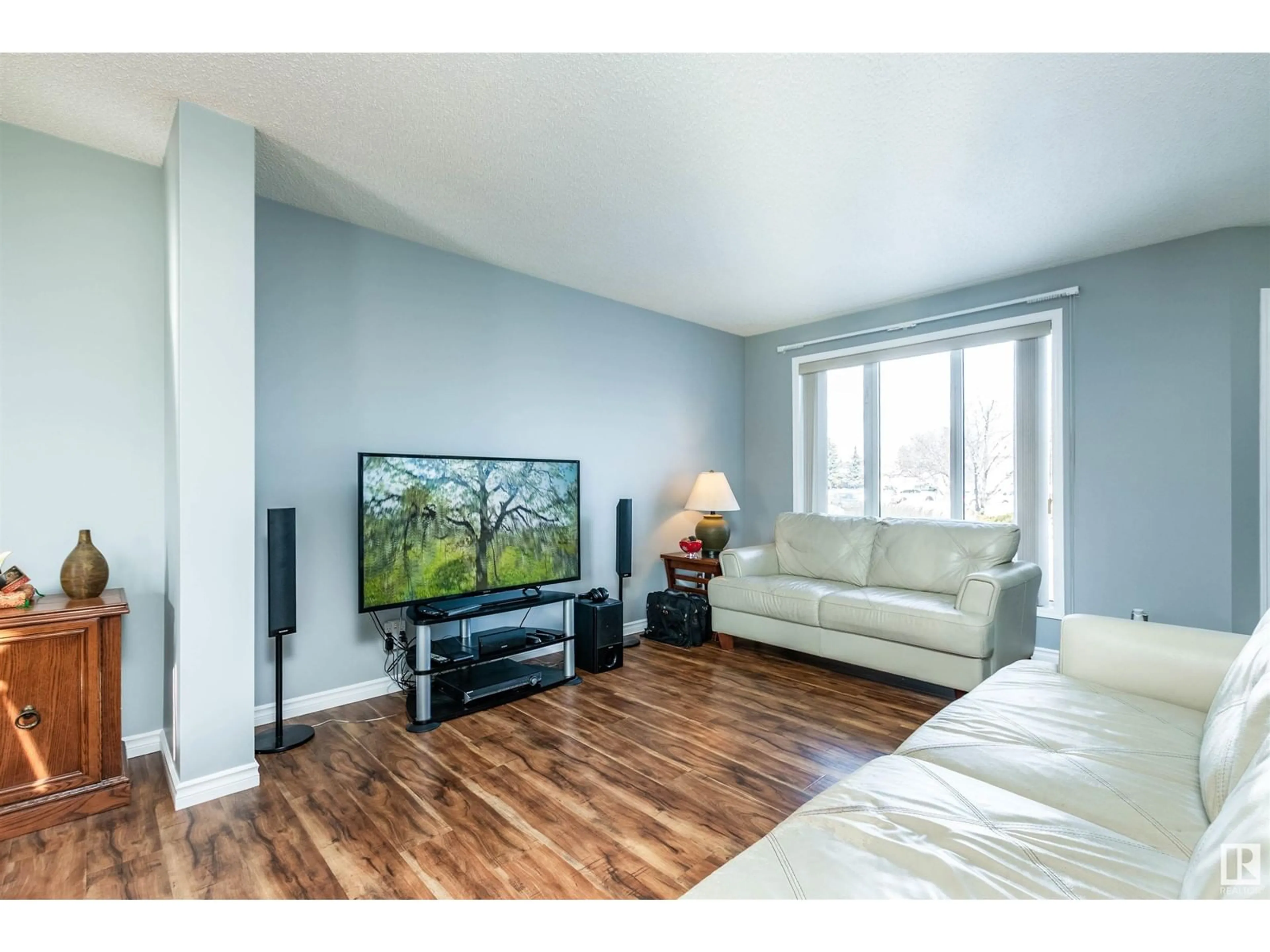 Living room with furniture, wood/laminate floor for 7715 154 AV NW, Edmonton Alberta T5Z2Z2