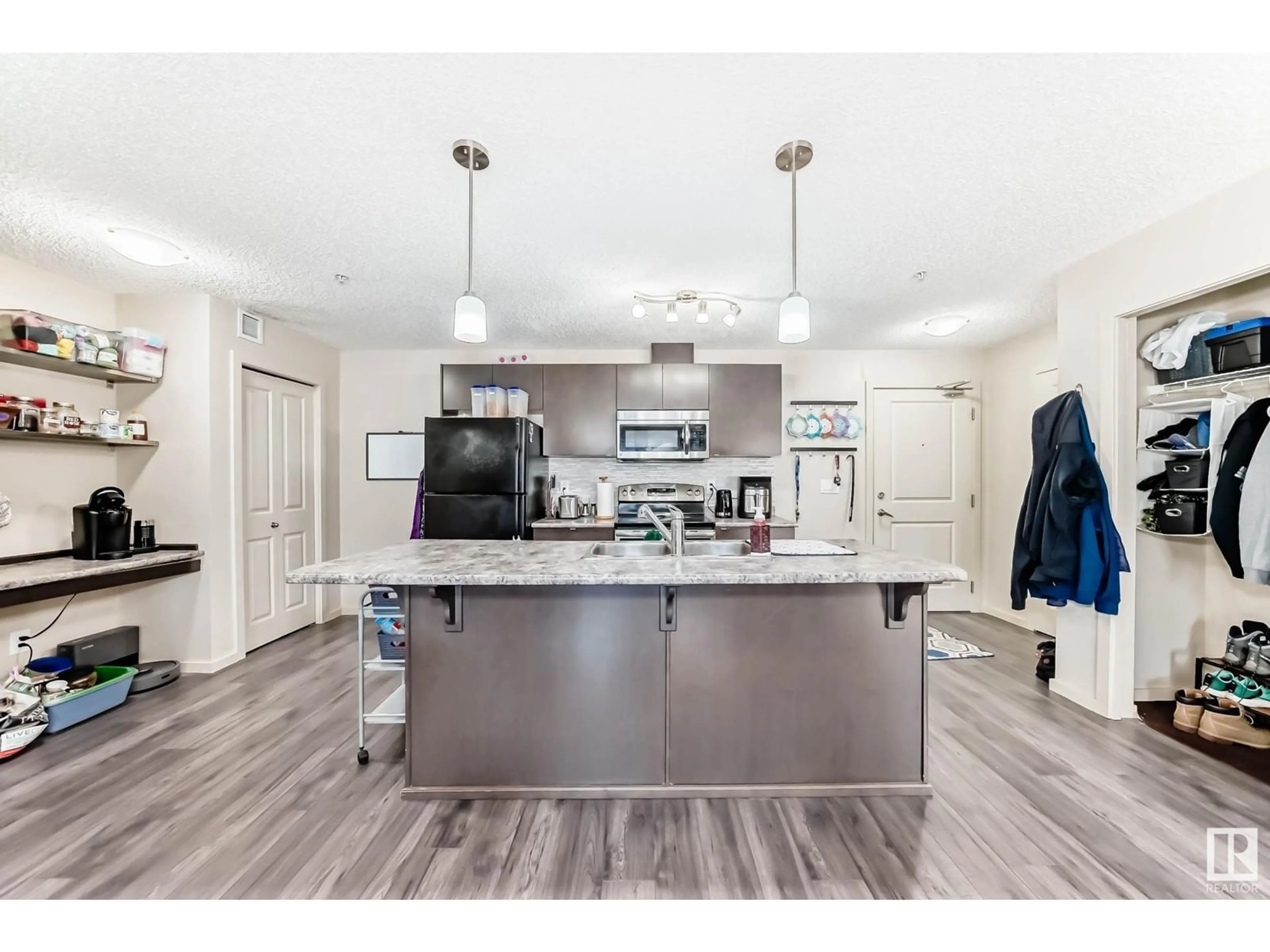 Open concept kitchen, wood/laminate floor for #305 3353 16A AV NW, Edmonton Alberta T6T0V4