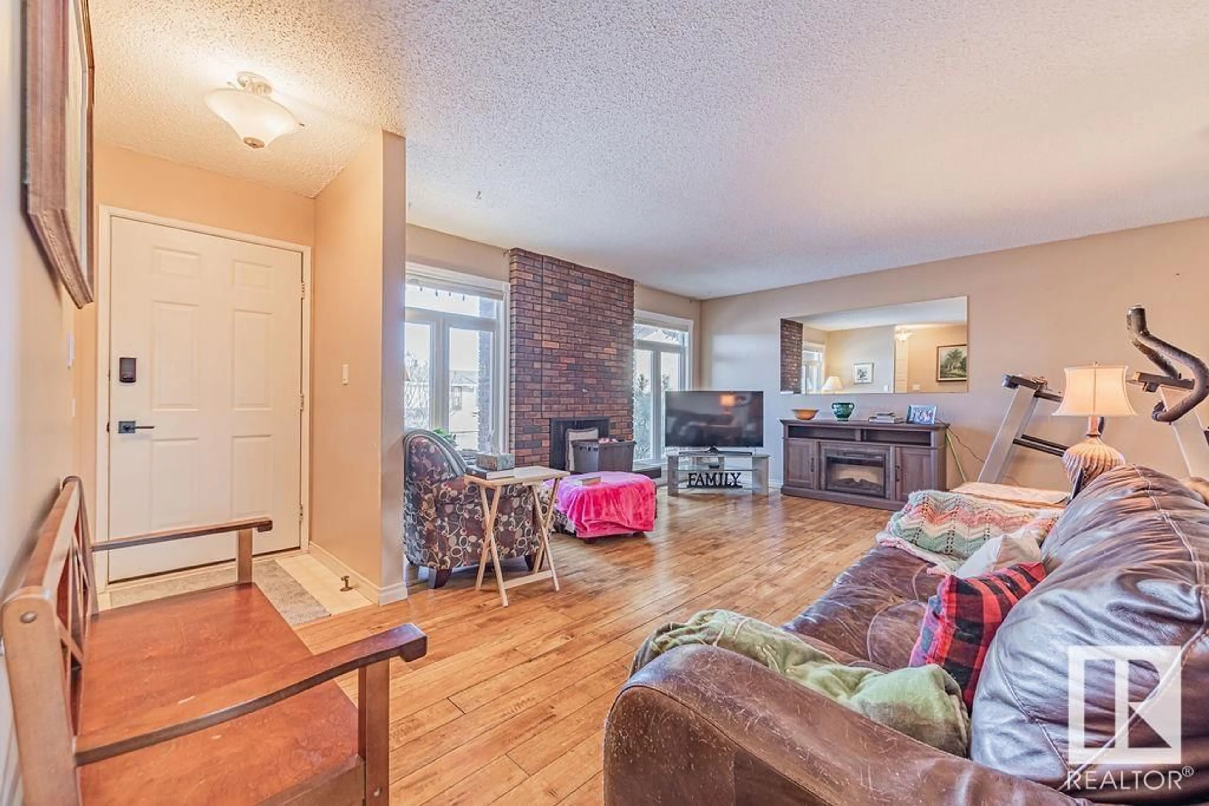 Living room with furniture, wood/laminate floor for 10305 167A AV NW, Edmonton Alberta T5X2Y8