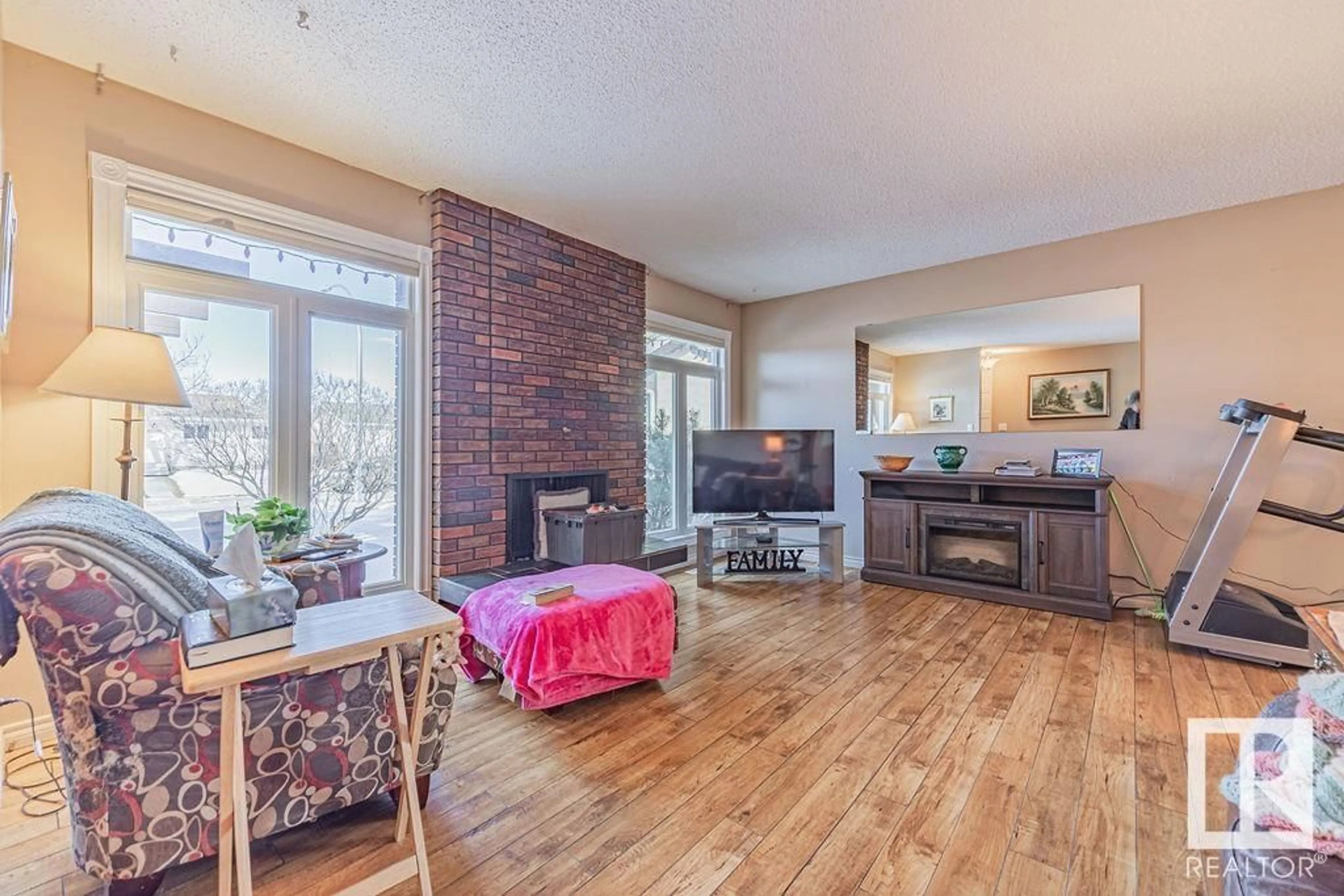 Living room with furniture, wood/laminate floor for 10305 167A AV NW, Edmonton Alberta T5X2Y8