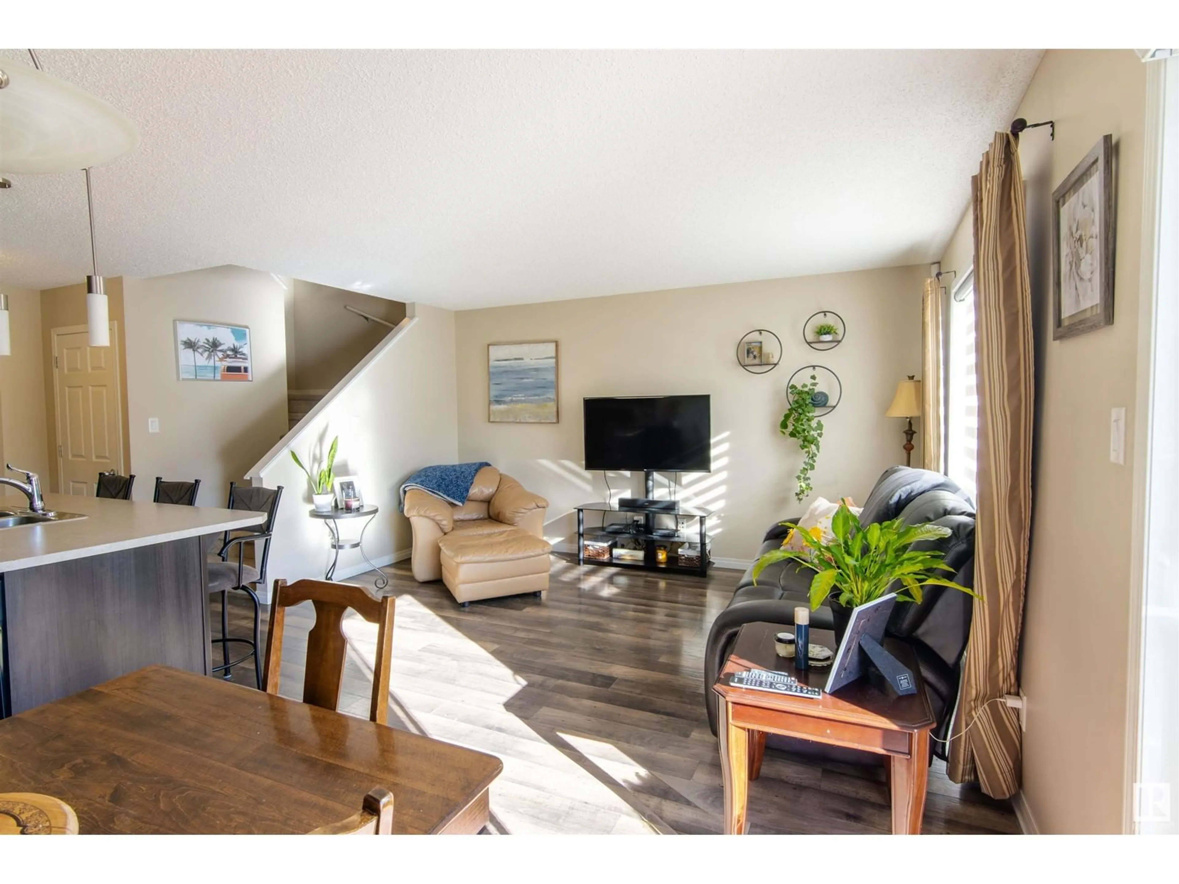 Living room with furniture, wood/laminate floor for 4689 CRABAPPLE RUN SW, Edmonton Alberta T6X0Y8