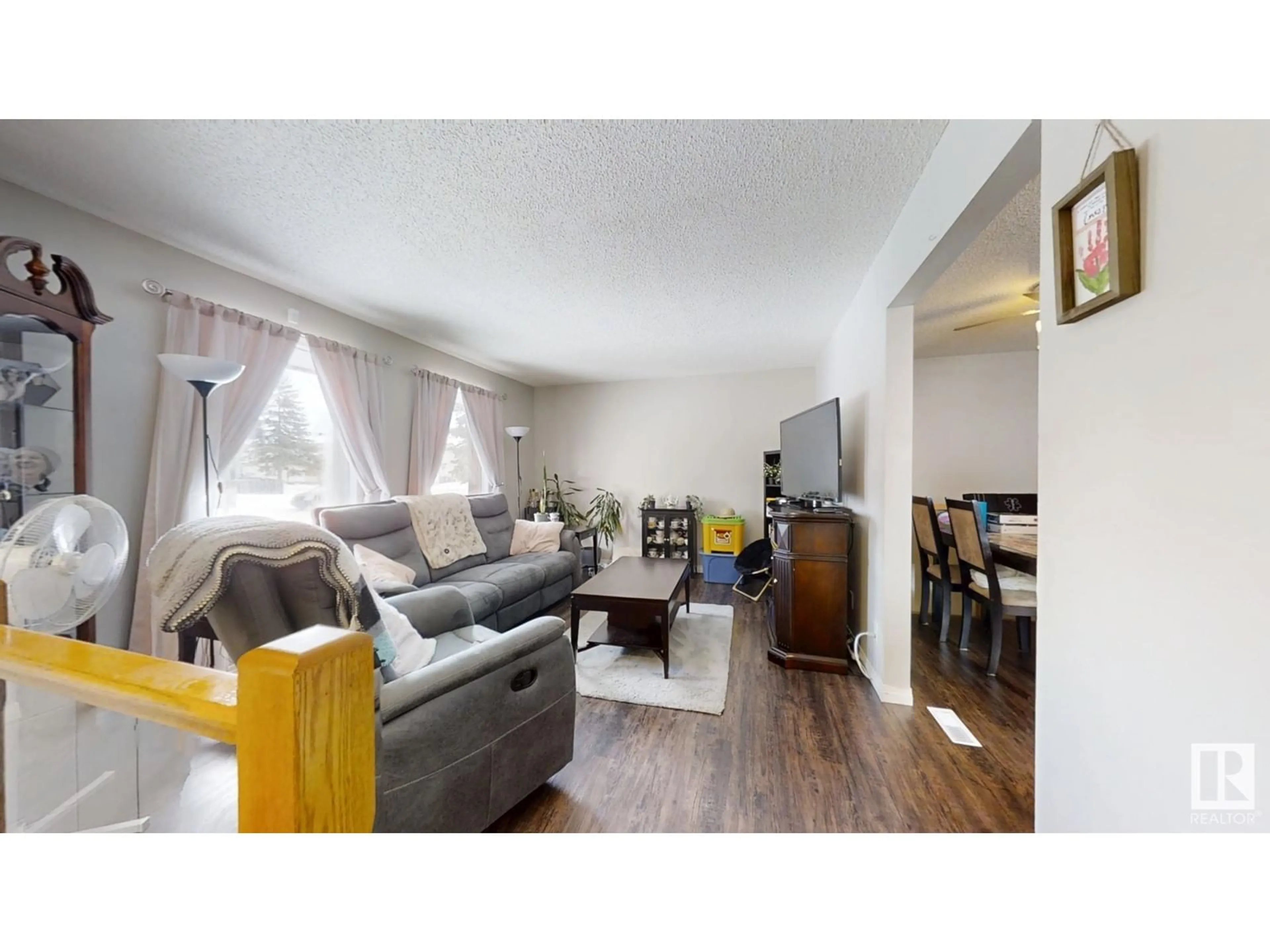 Living room with furniture, wood/laminate floor for 1230 62 St NW, Edmonton Alberta T6L2H9