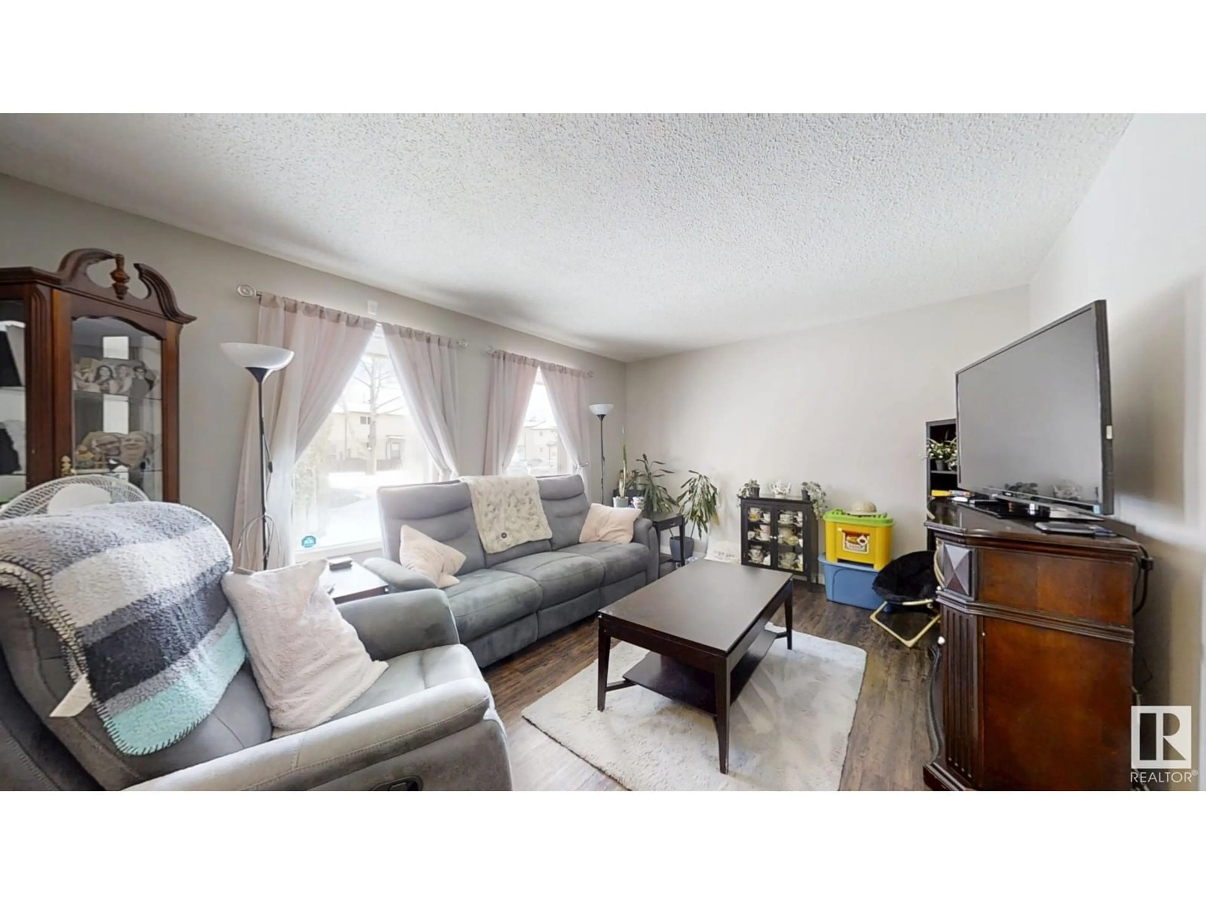 Living room with furniture, wood/laminate floor for 1230 62 St NW, Edmonton Alberta T6L2H9